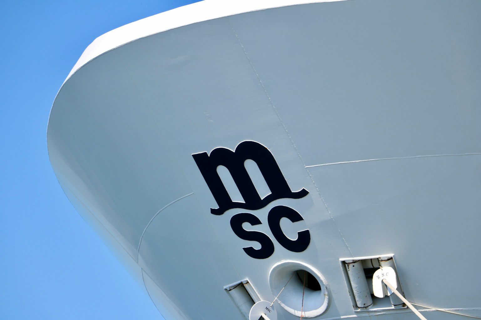 Bow of a ship featuring the MSC logo against a blue sky