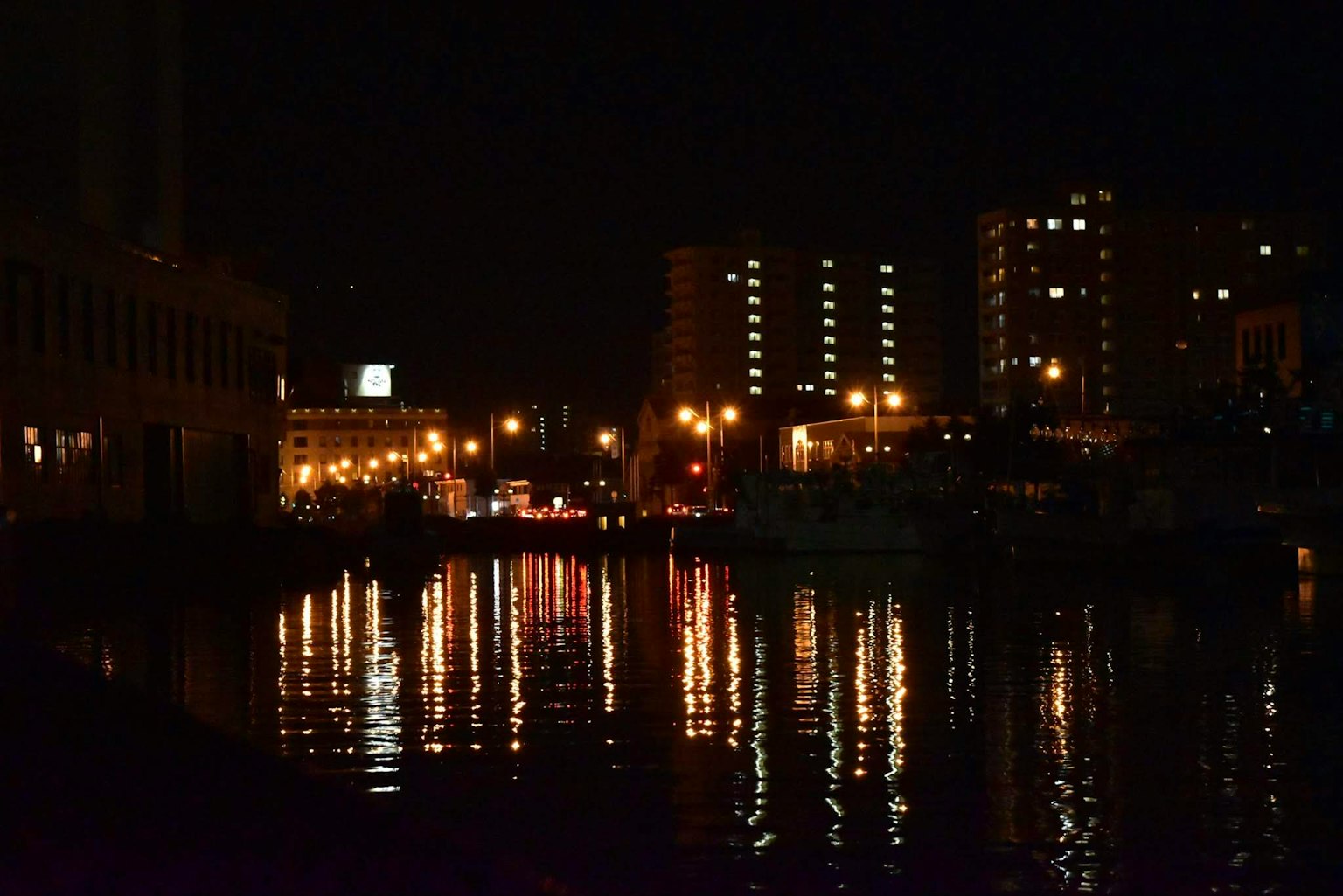 Night cityscape with reflections of lights on the water