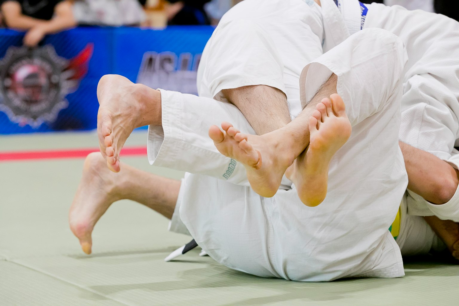 Feet of judo competitors entangled during a match