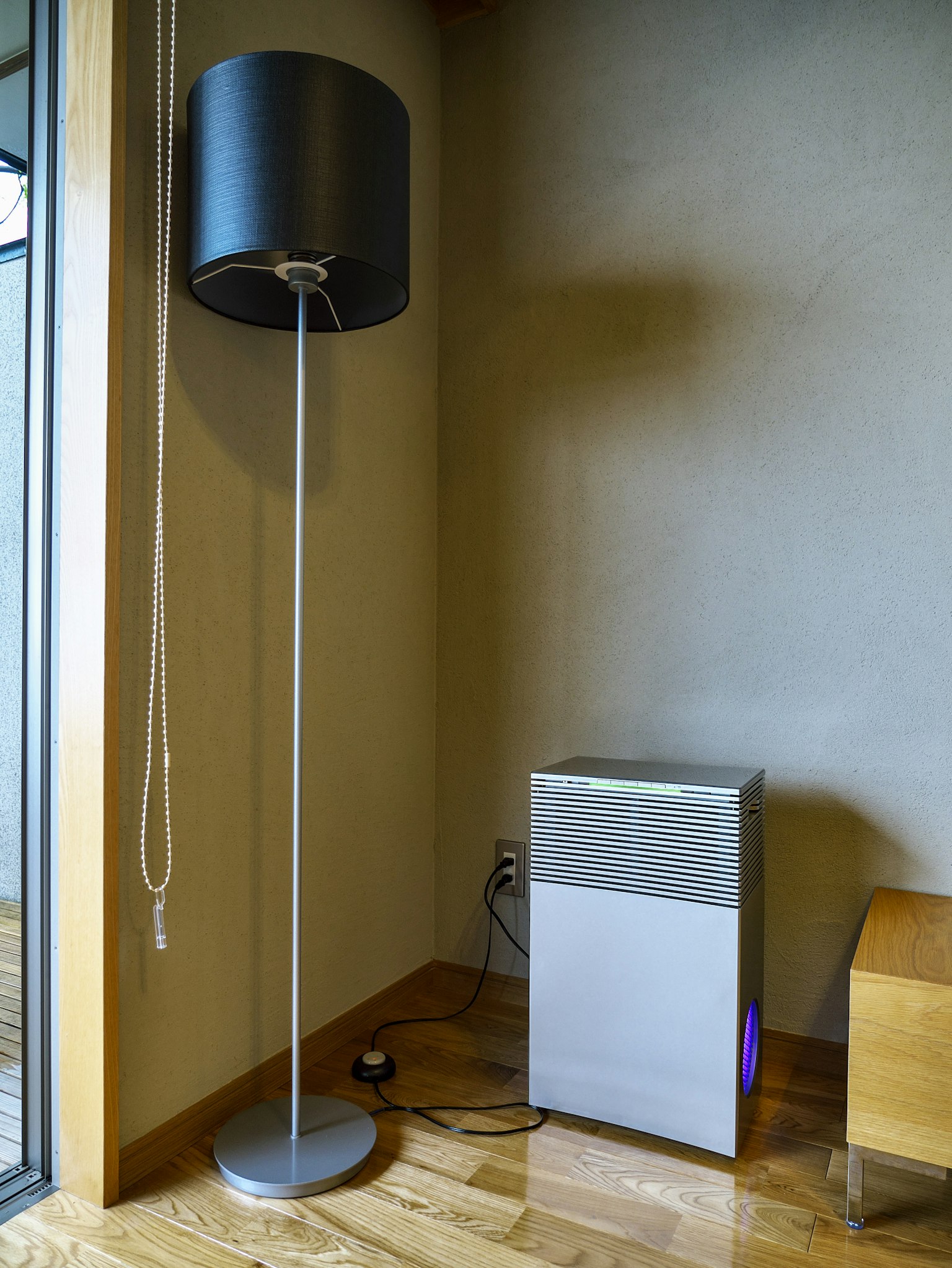 Modern floor lamp and air purifier in a room corner