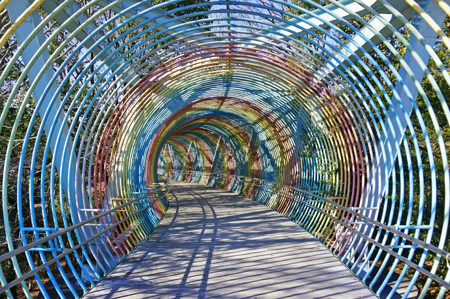 Colorful metal tunnel structure with visible walkway