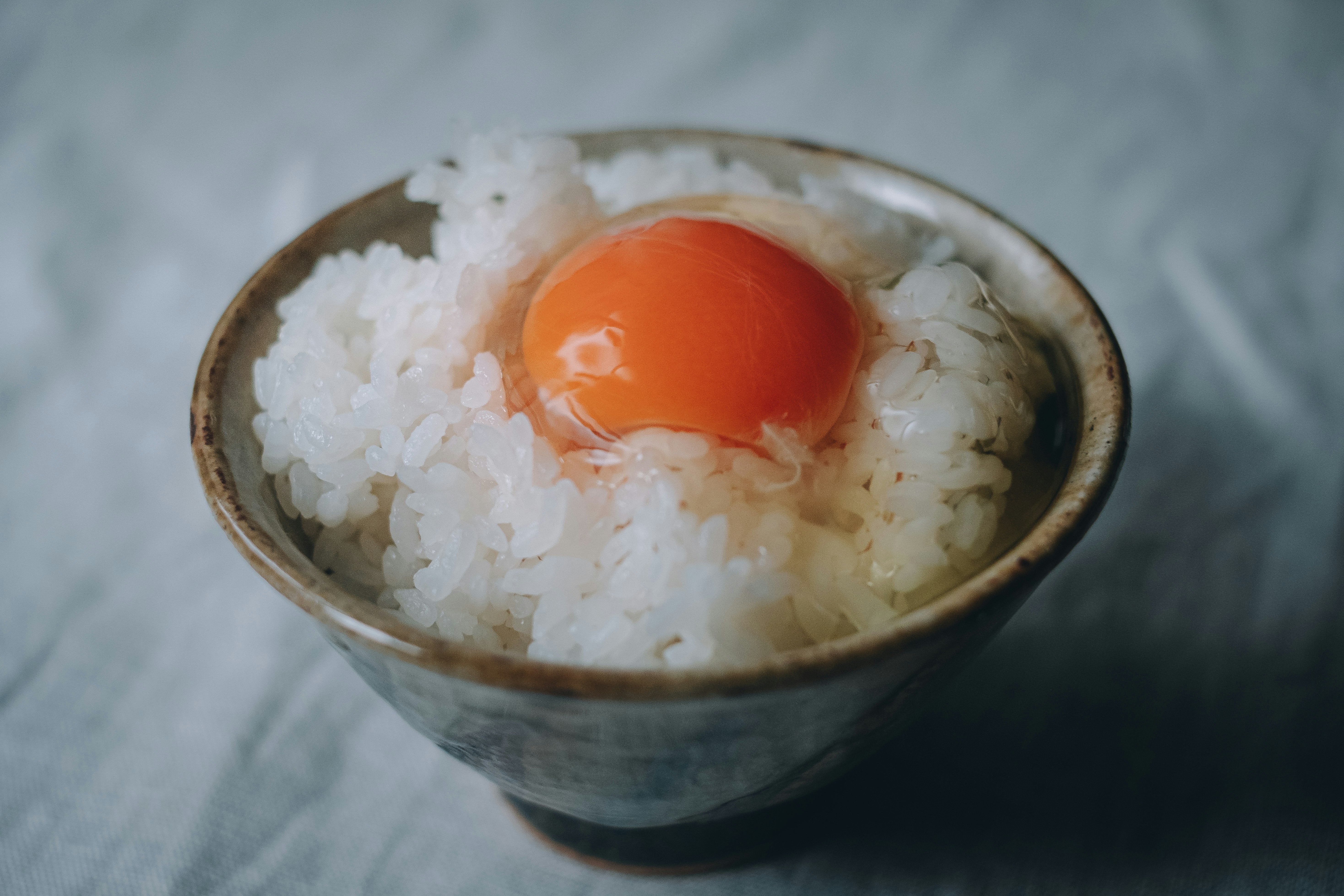 bowl of white rice with a soft-boiled egg