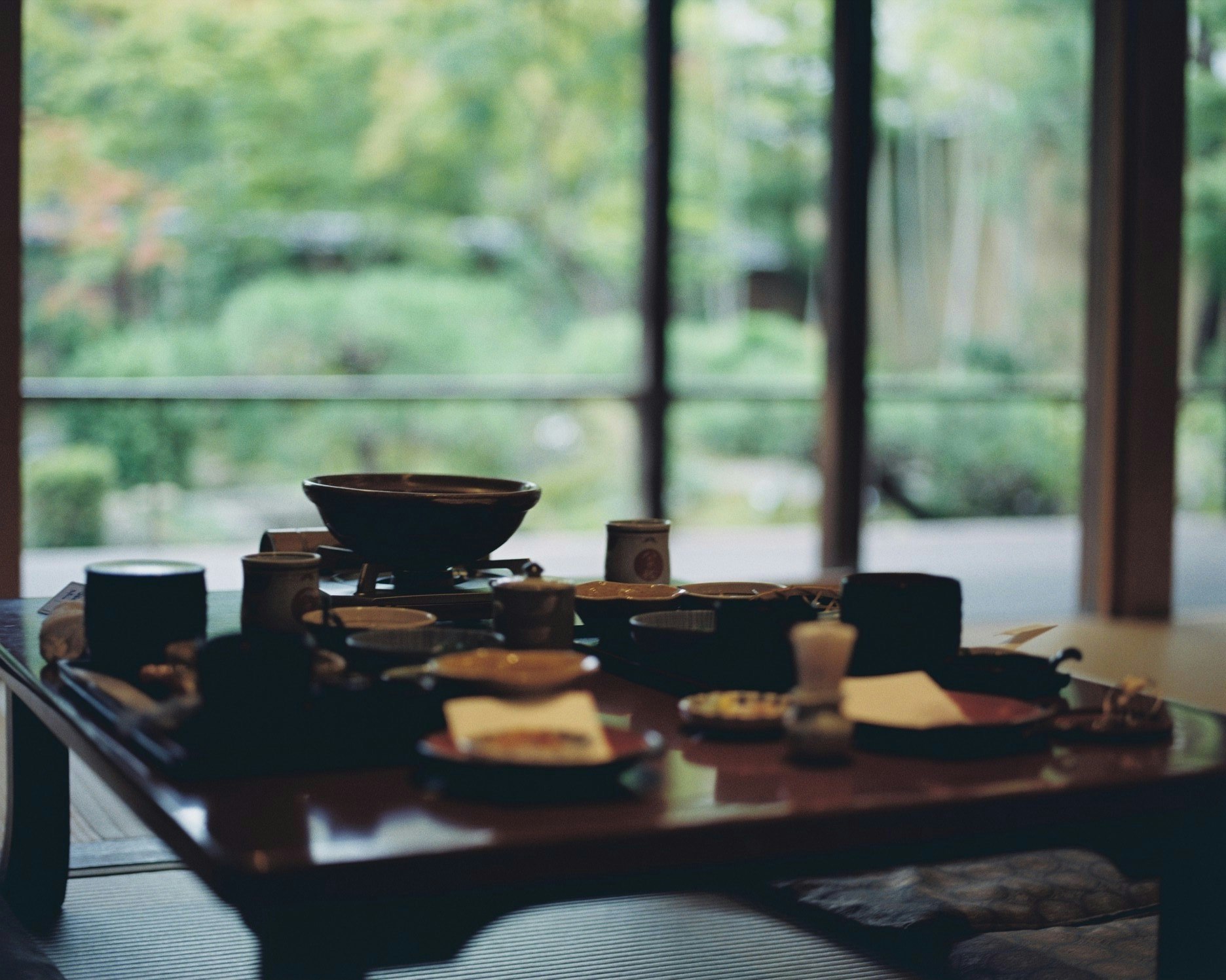 Tea set on a wooden table by a window