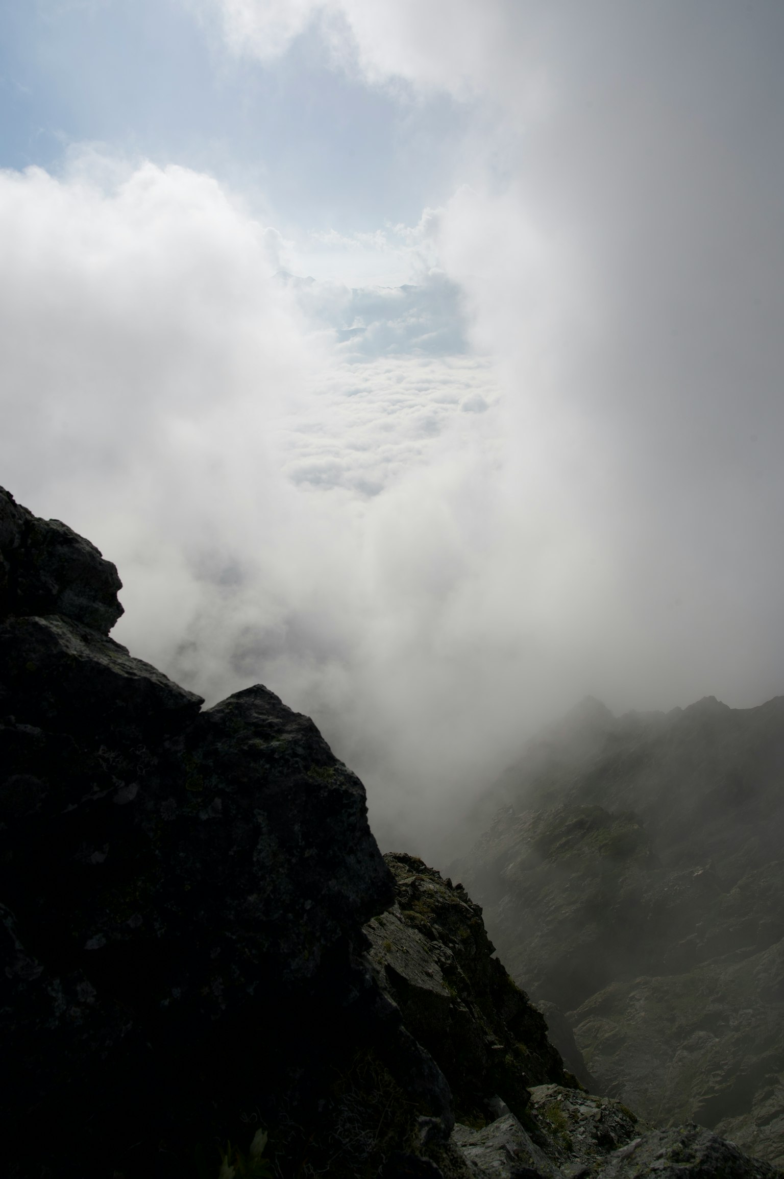 View from a rocky peak overlooking a sea of clouds