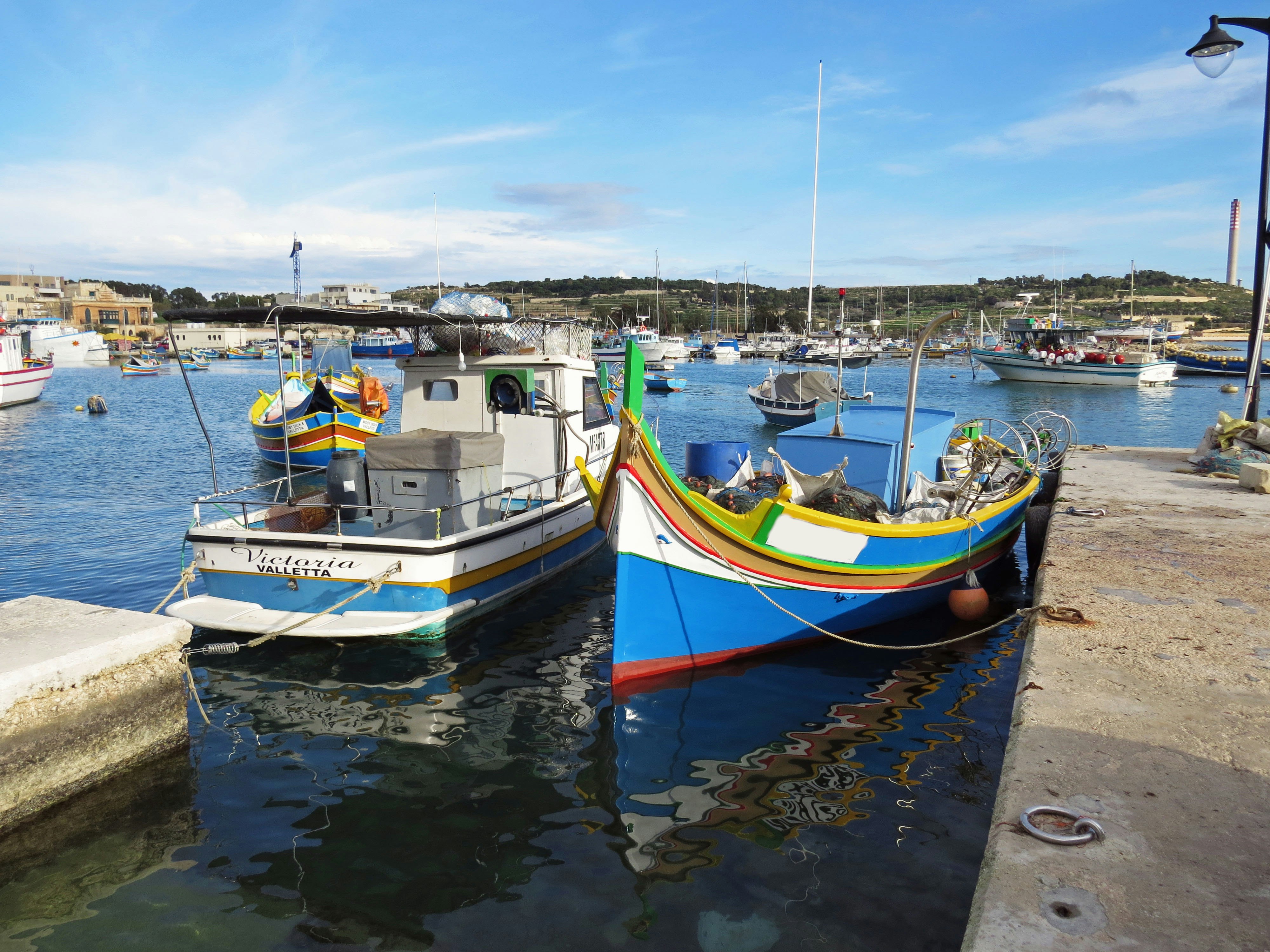 small fishing boats lined up at a harbor dock