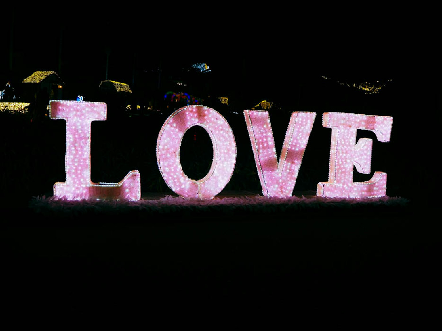 Large pink LOVE letters illuminated at night