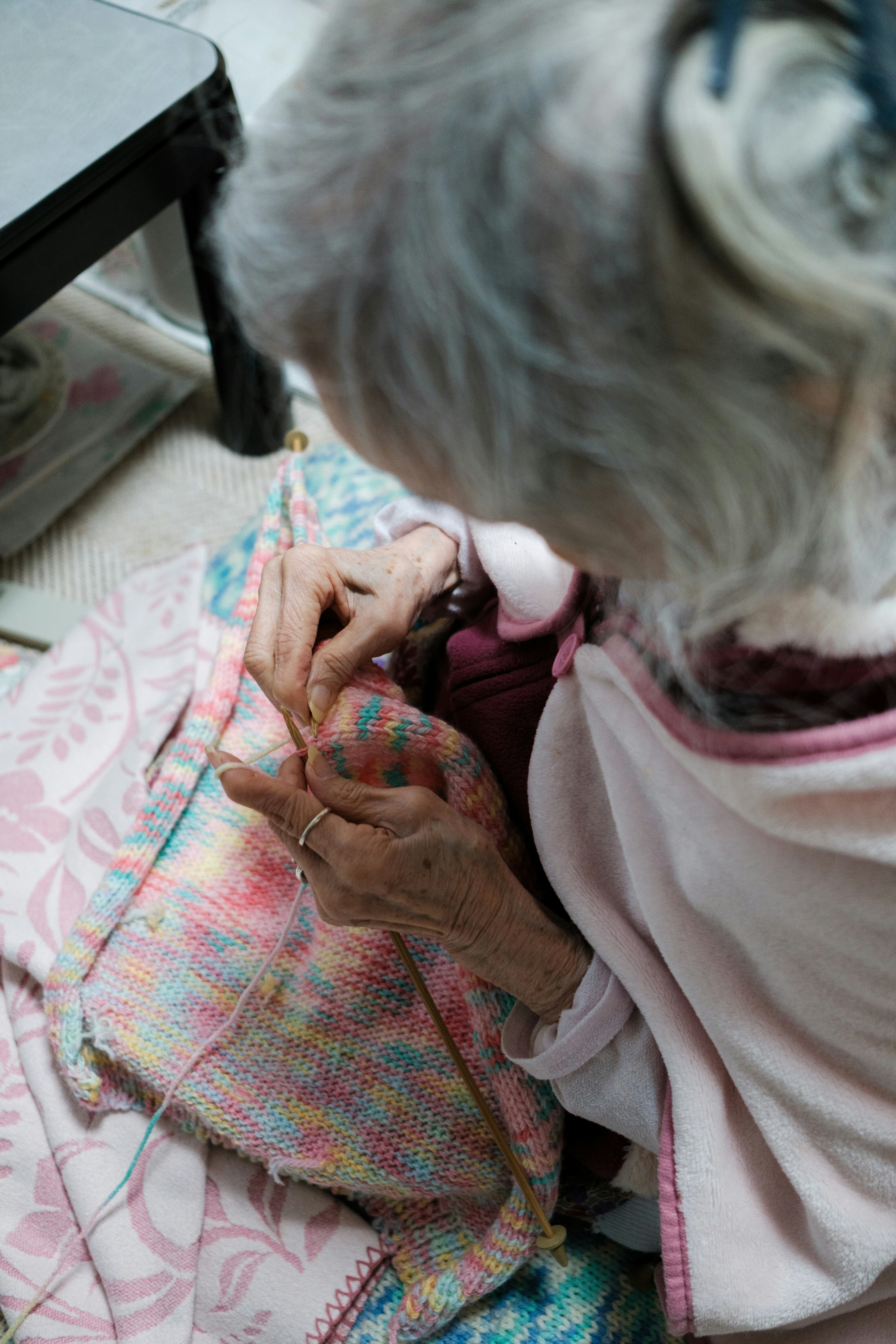 Grandmother adjusting a baby’s clothing with her hands