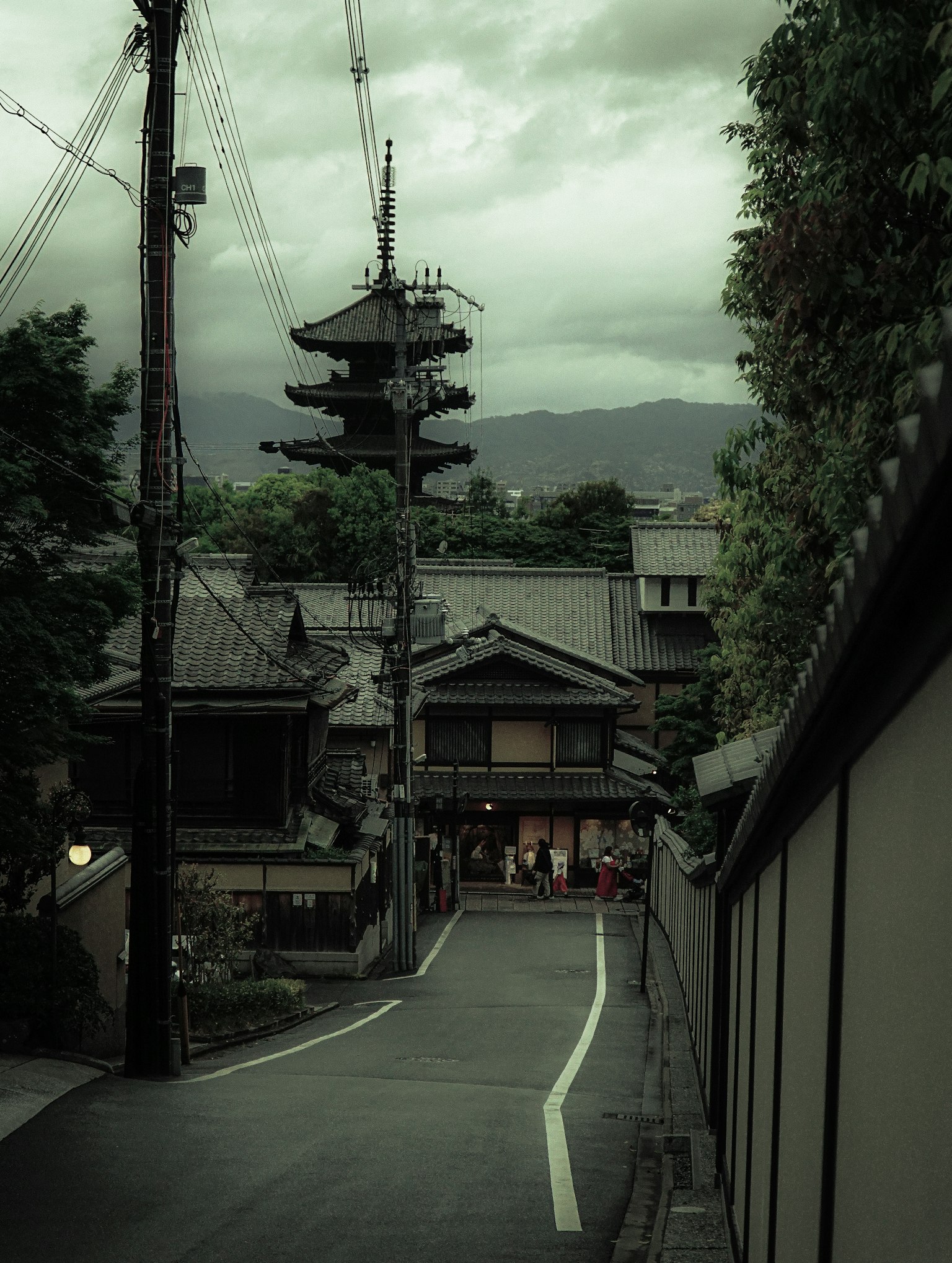 Quiet street scene featuring traditional Japanese architecture and a pagoda
