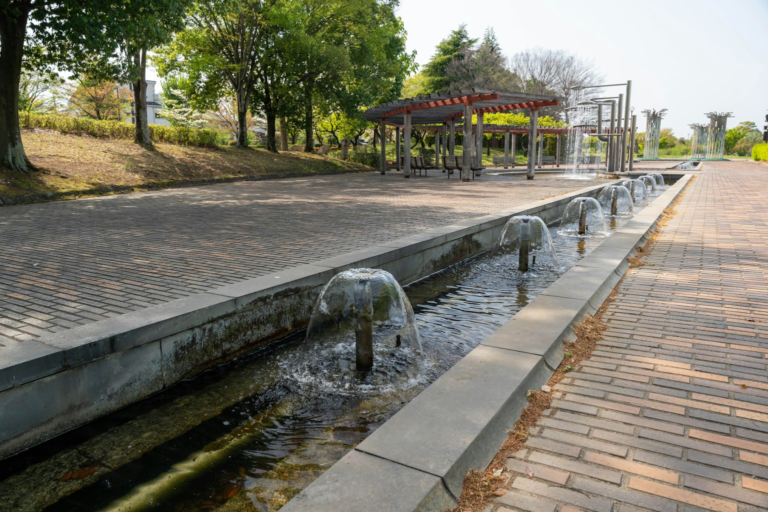 Park scene featuring a water flow and play area