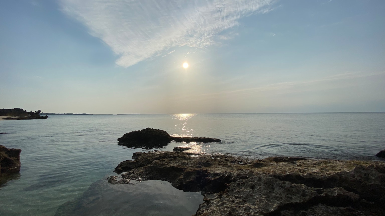 宁静的海景与岩石阳光在水面上反射