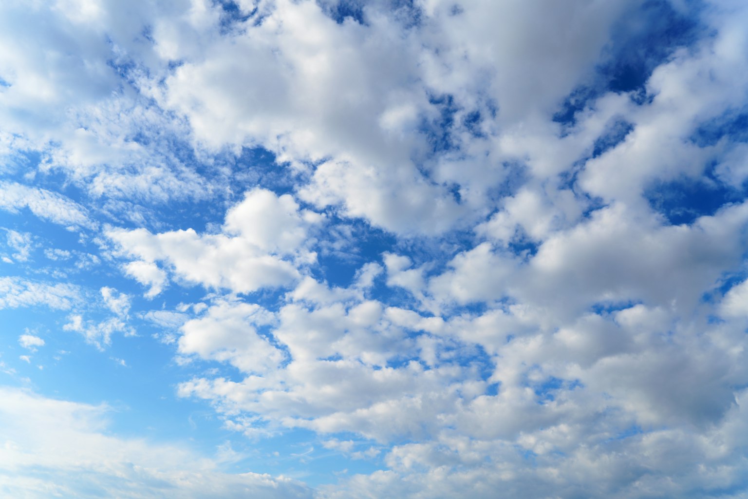Expansive white clouds in a clear blue sky