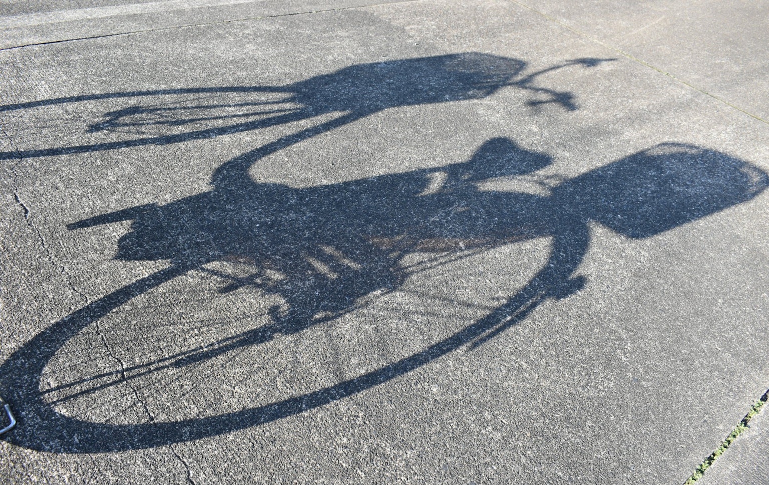 Shadow of a bicycle on the pavement