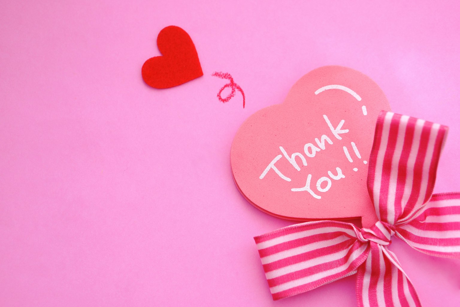 Pink background with a red heart and a pink heart saying Thank You