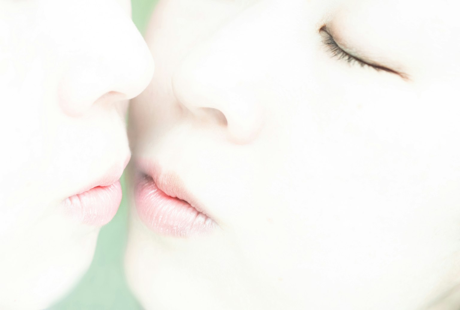 Close-up of two faces almost touching in a gentle moment