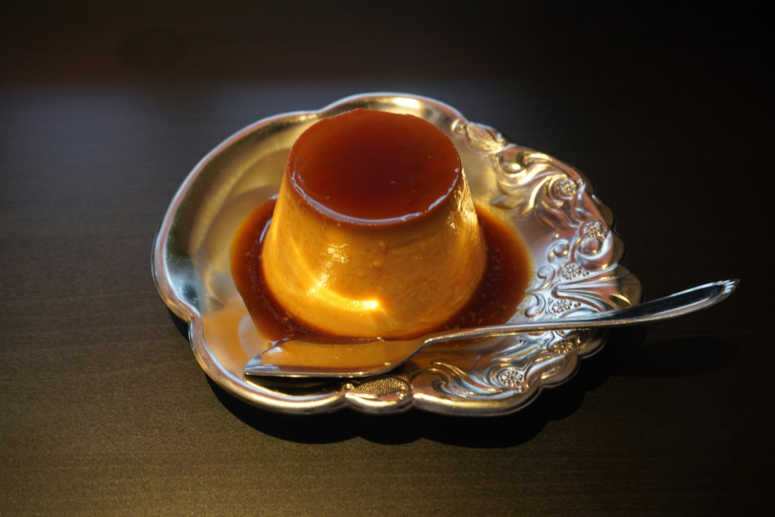 ฟลานครีมราดด้วยซอสคาราเมลบนจานเงินเงา