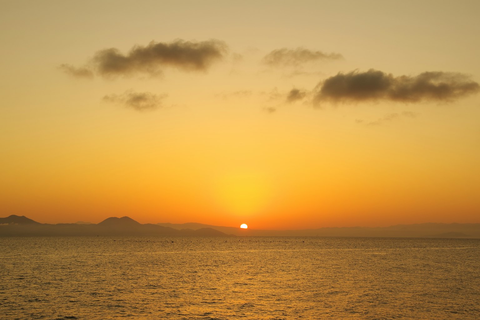 Orange sunset over the sea with clouds