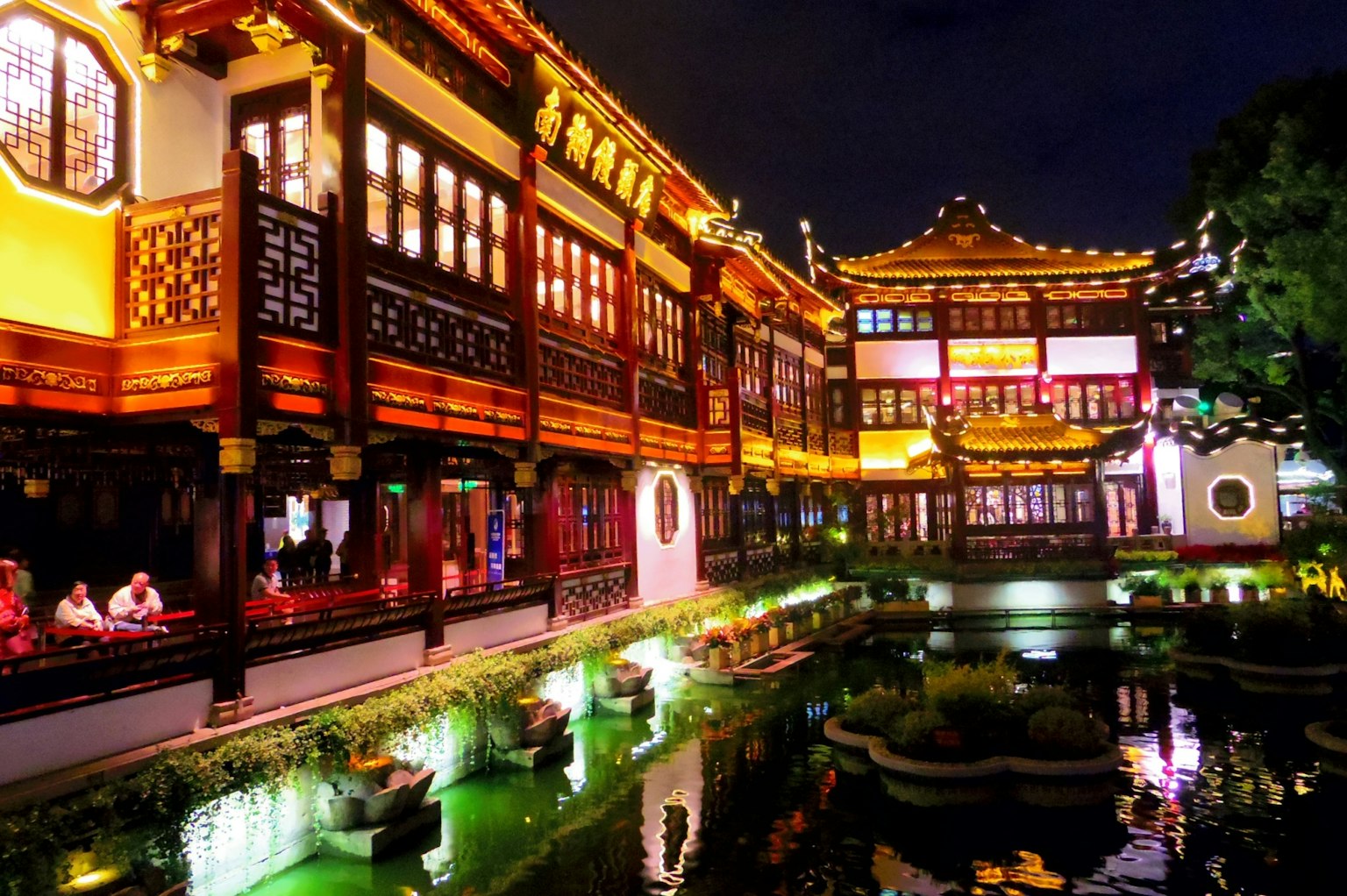 Kiến trúc Trung Quốc truyền thống được chiếu sáng vào ban đêm với một cái ao yên tĩnh