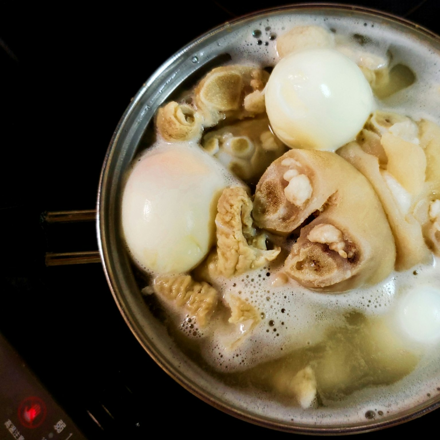 Dish of boiled eggs and meat in a pot
