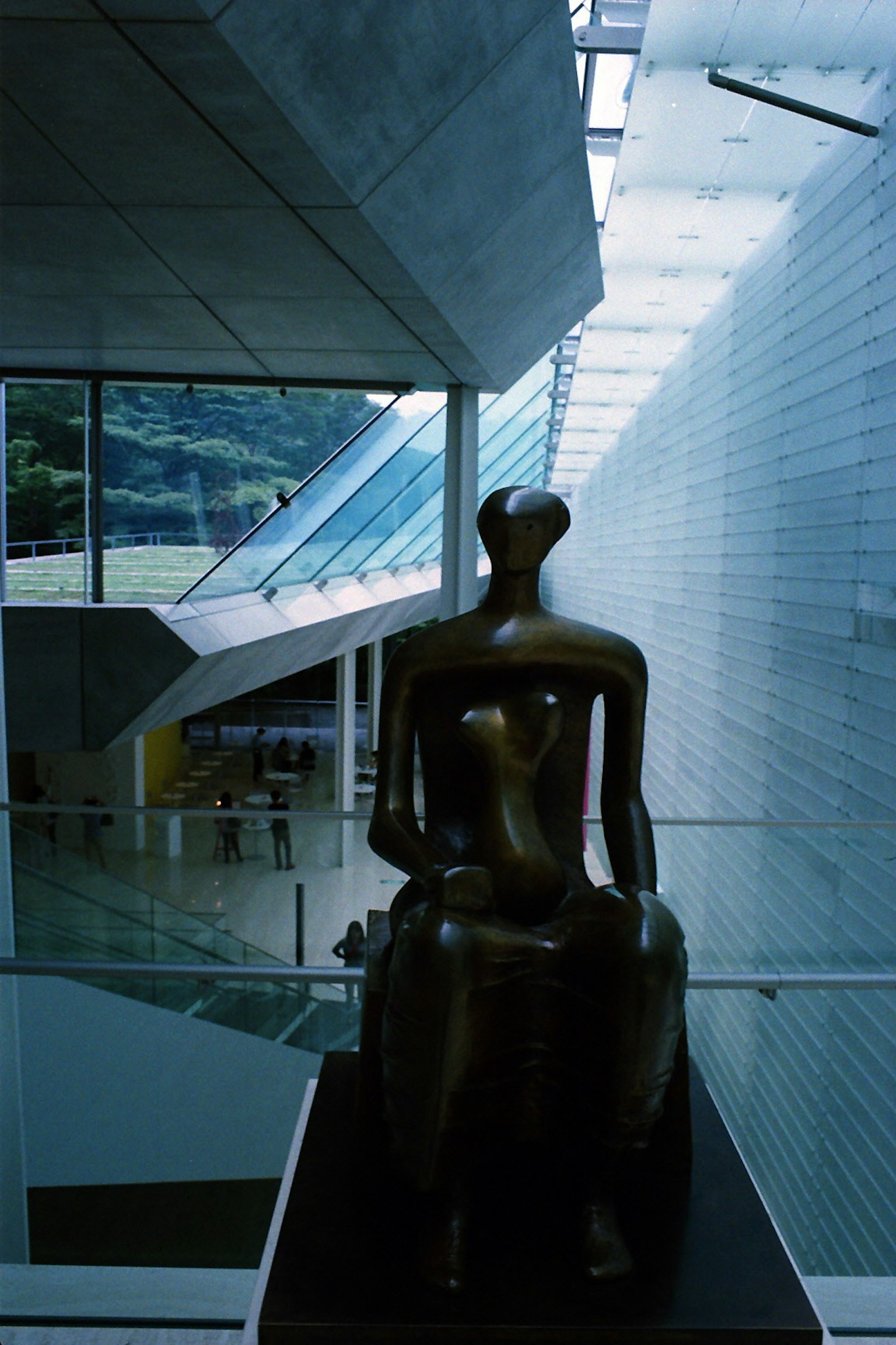 Interior view of a modern art museum featuring a bronze sculpture
