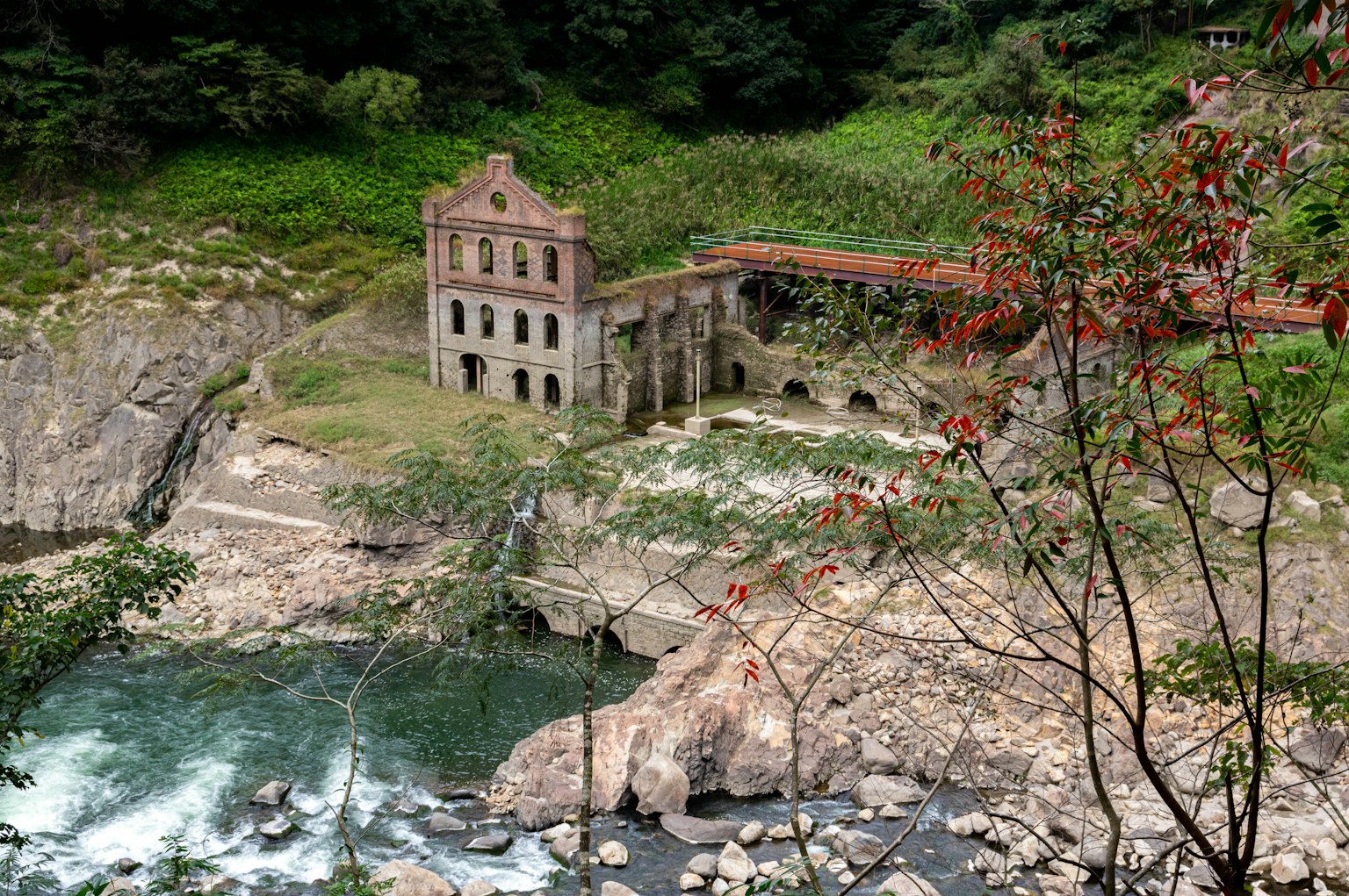 Ruined hydroelectric power station near a river