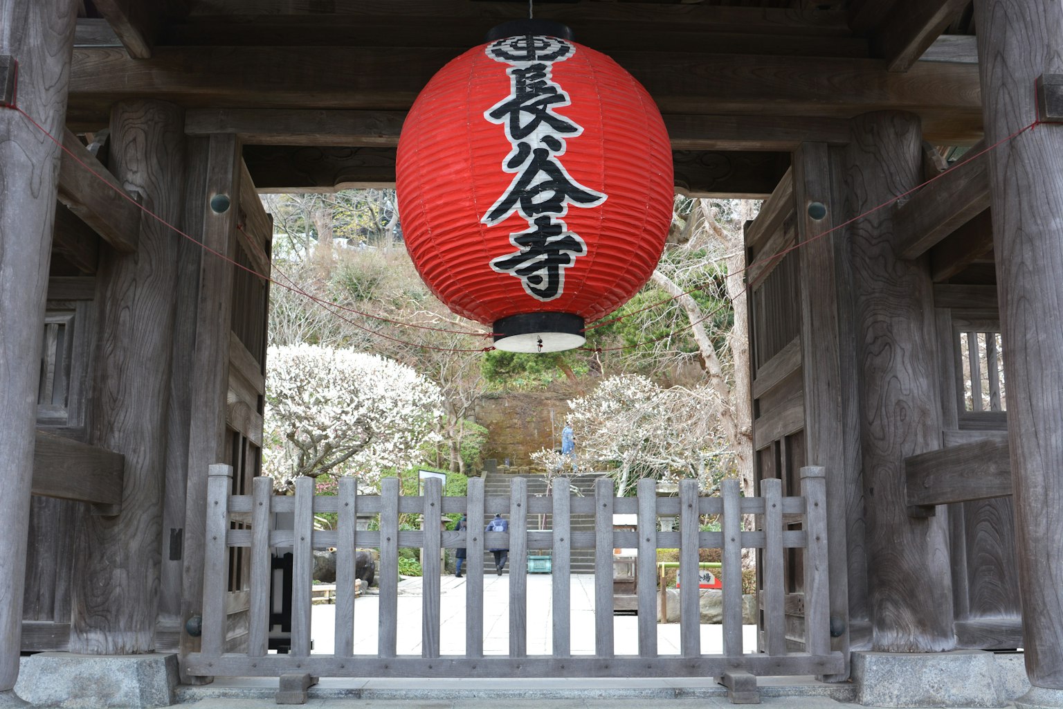 Vista de una puerta con una linterna roja en el templo Hase-dera
