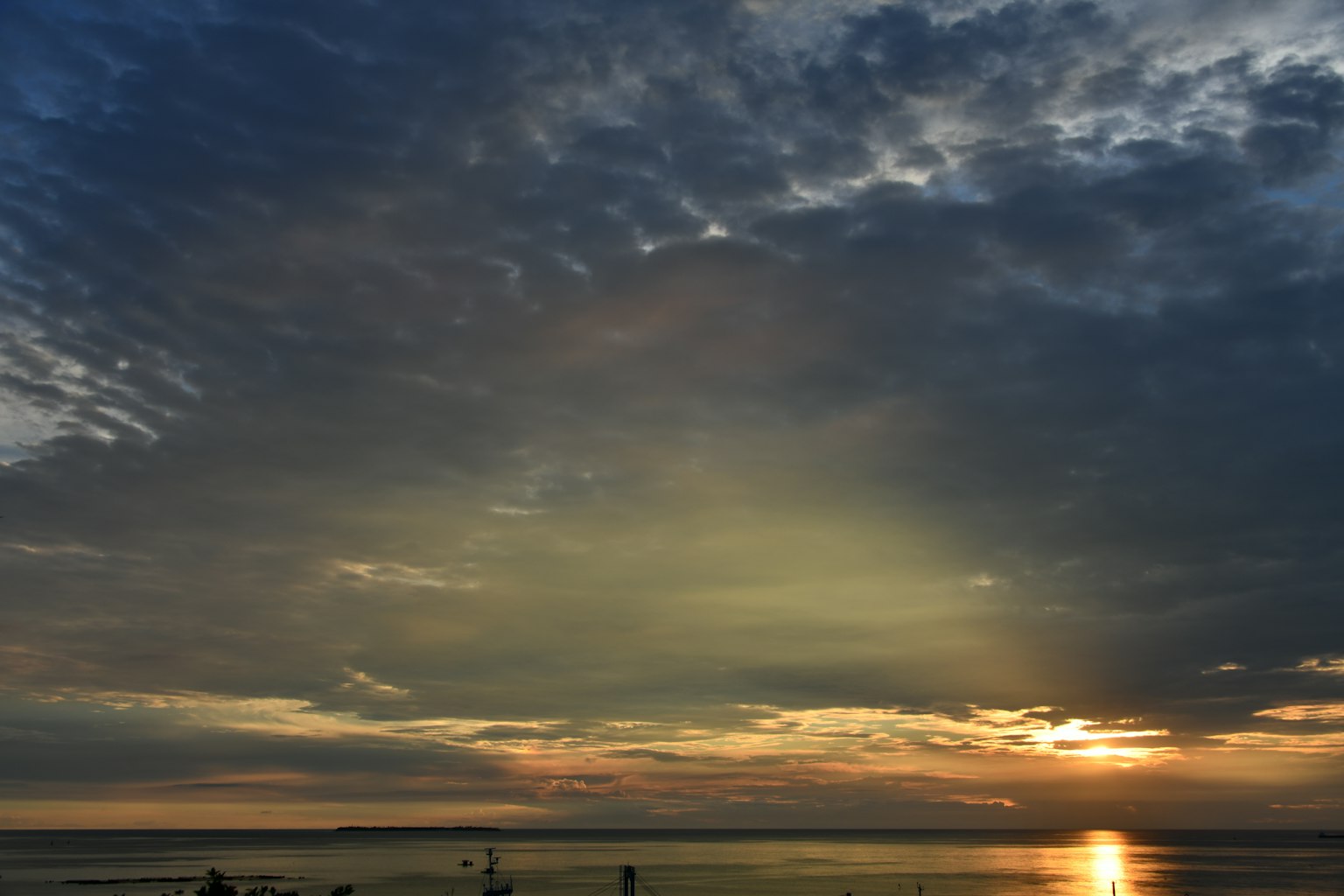 Paesaggio bellissimo con il tramonto che si riflette sul mare e un cielo nuvoloso