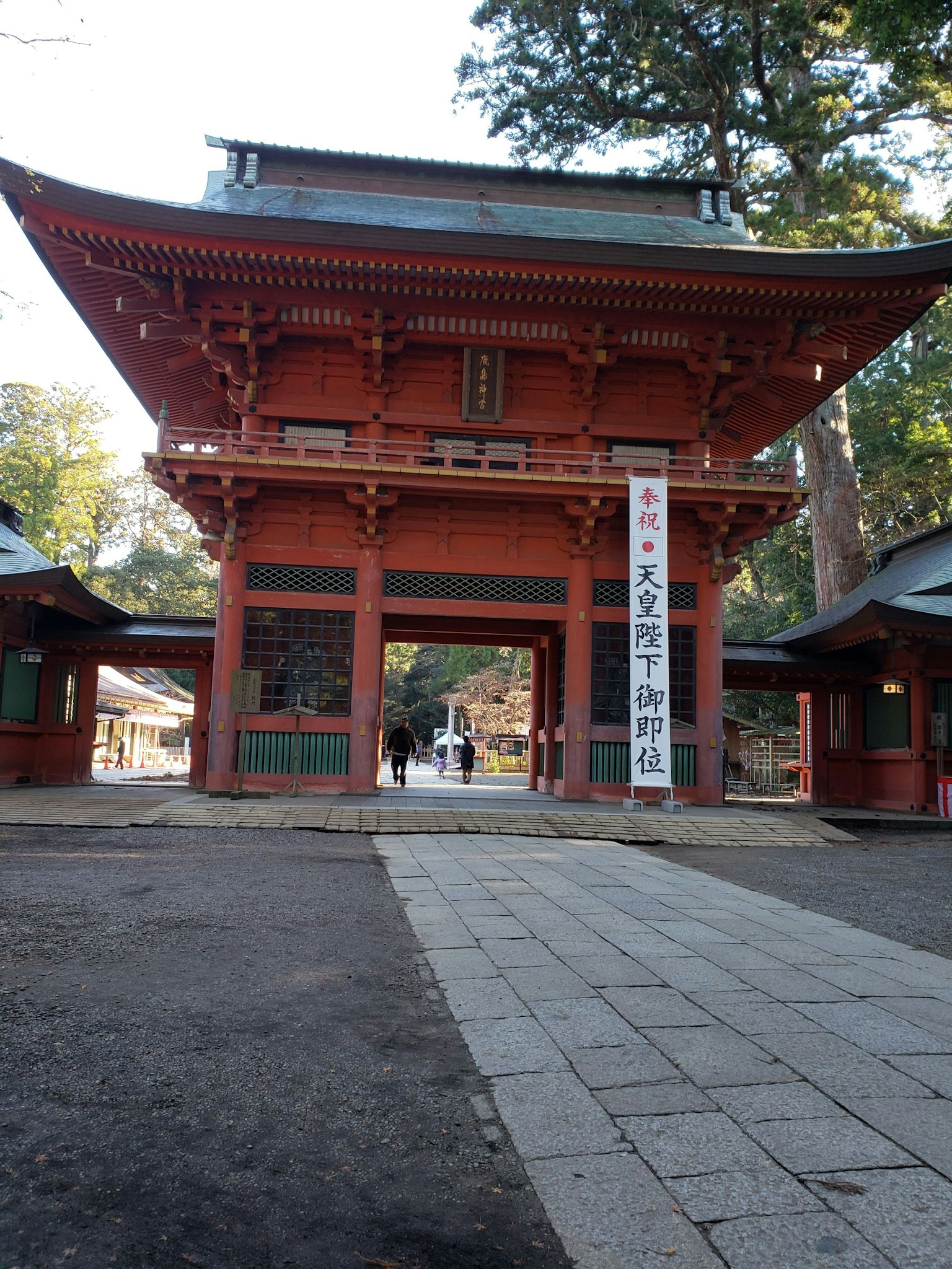 Red gate with surrounding buildings in a shrine setting