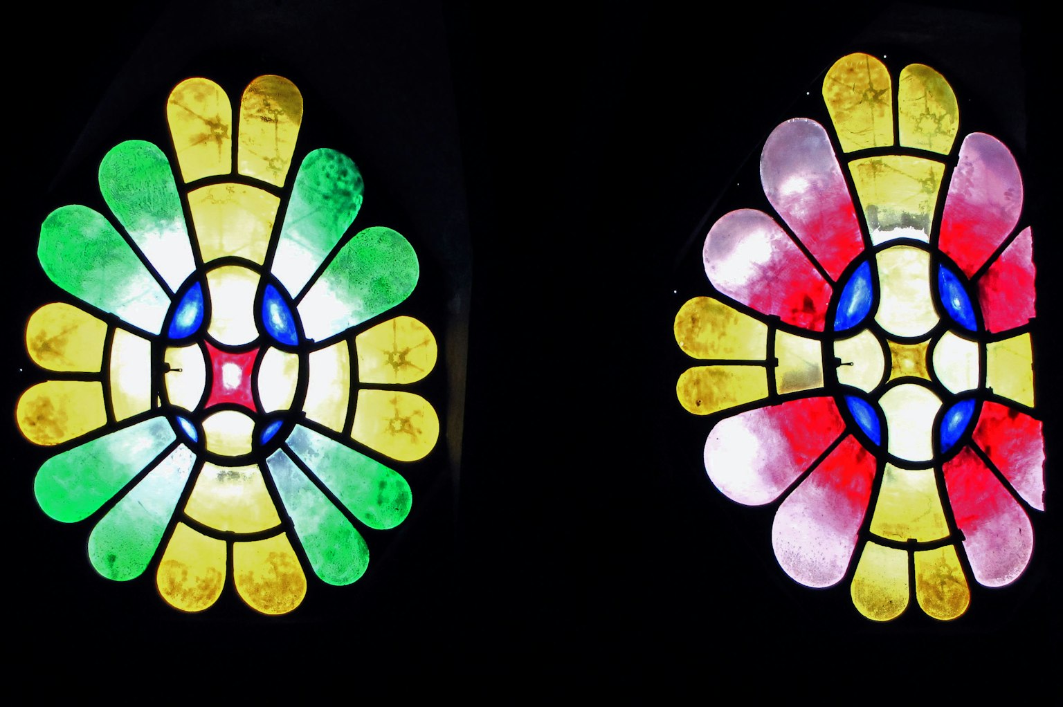 Zwei bunte Glasfensterdesigns mit Blumenmustern