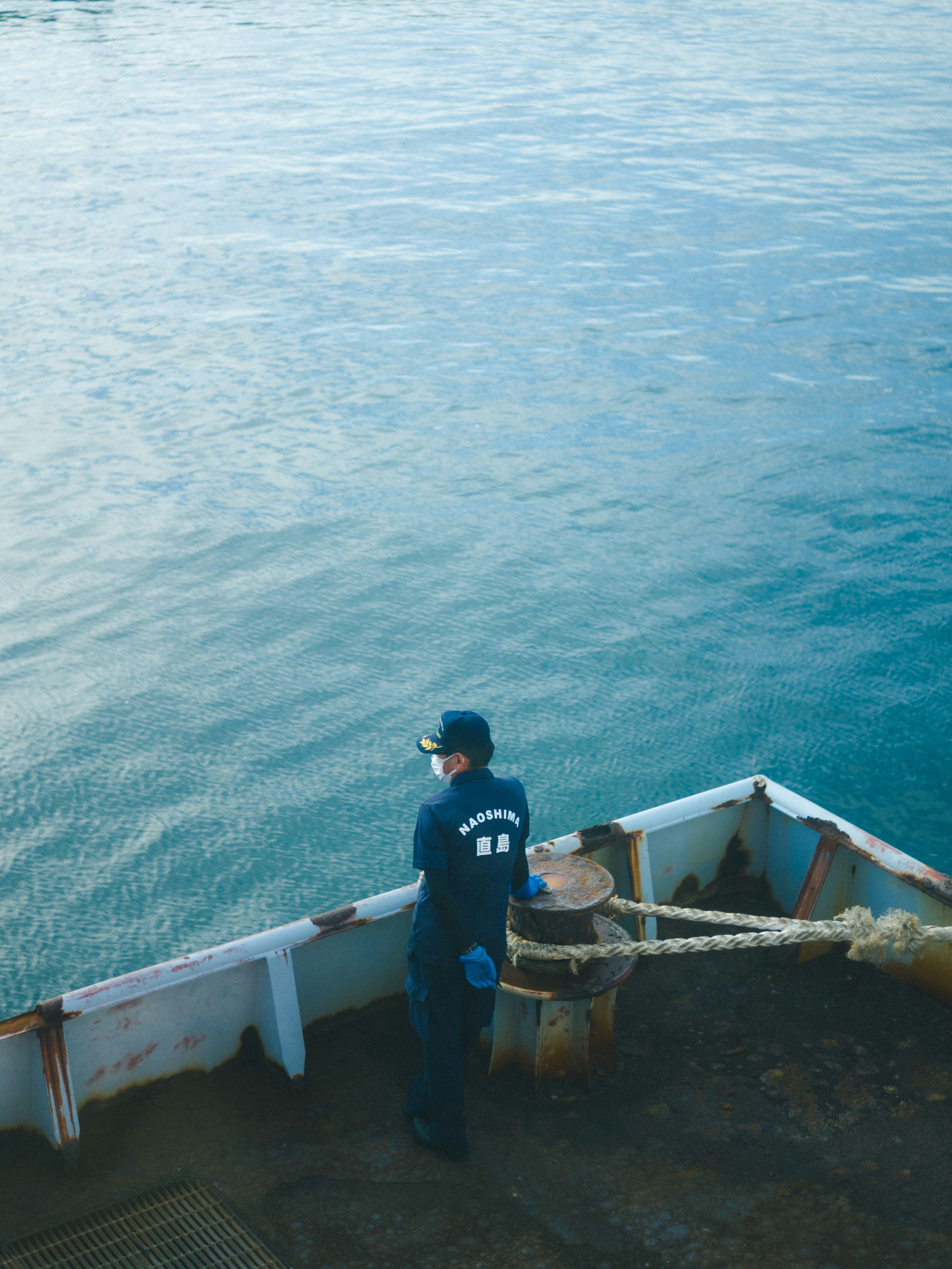 person on a boat overlooking Naoshima’s sea