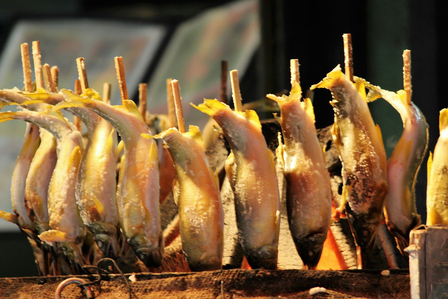 Pescado a la parrilla en brochetas expuesto en un vendedor ambulante