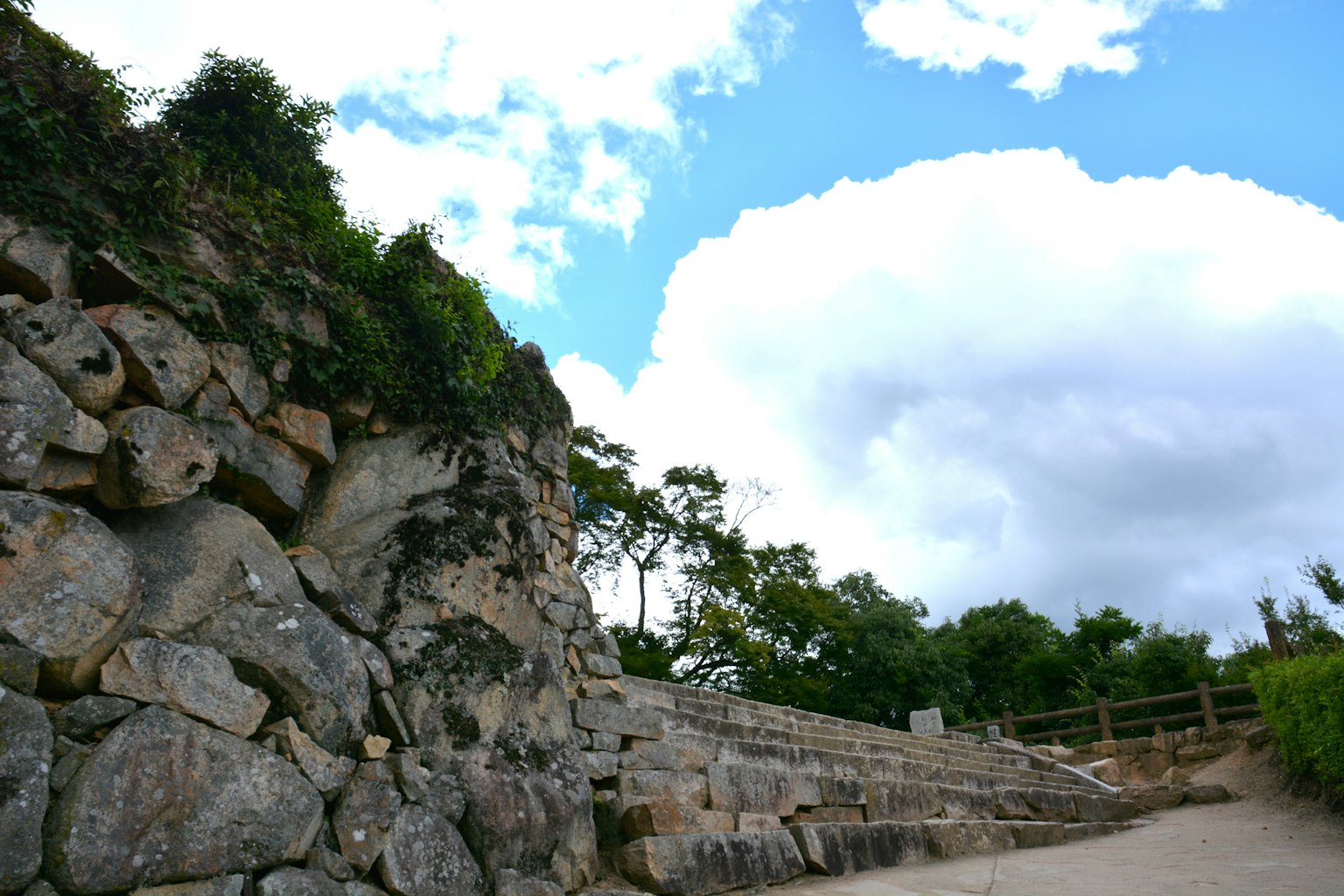 Rocky landscape with blue sky greenery and visible steps
