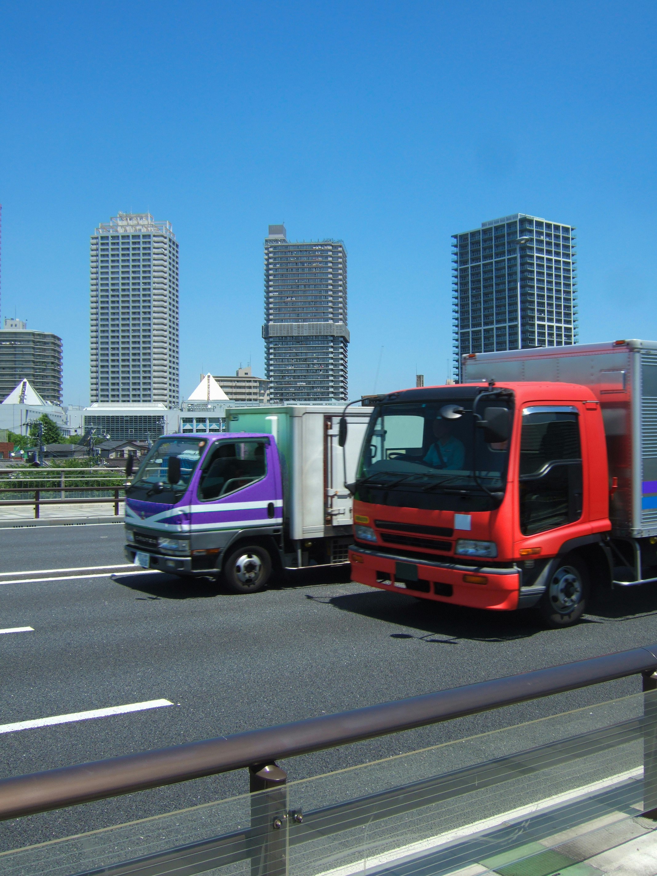 urban highway scene with trucks and buses