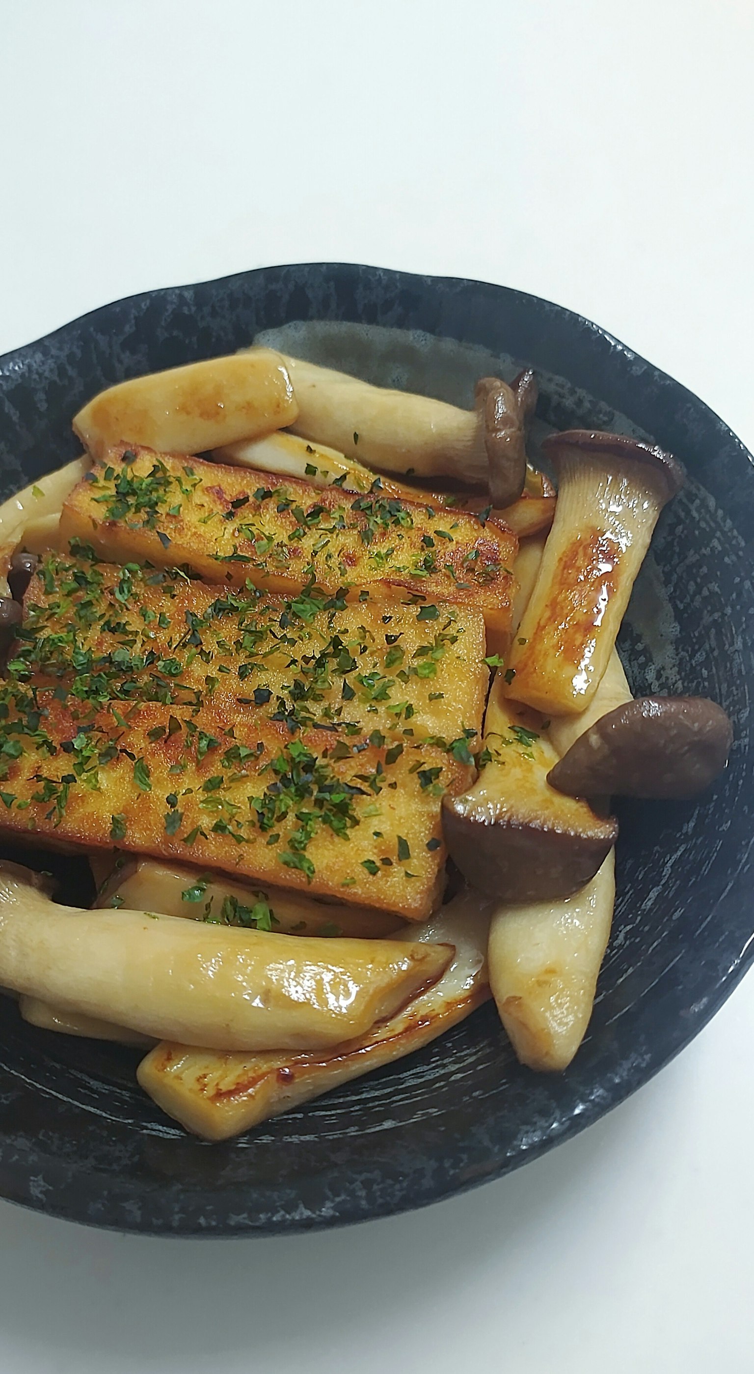 Plate of grilled fish with mushrooms