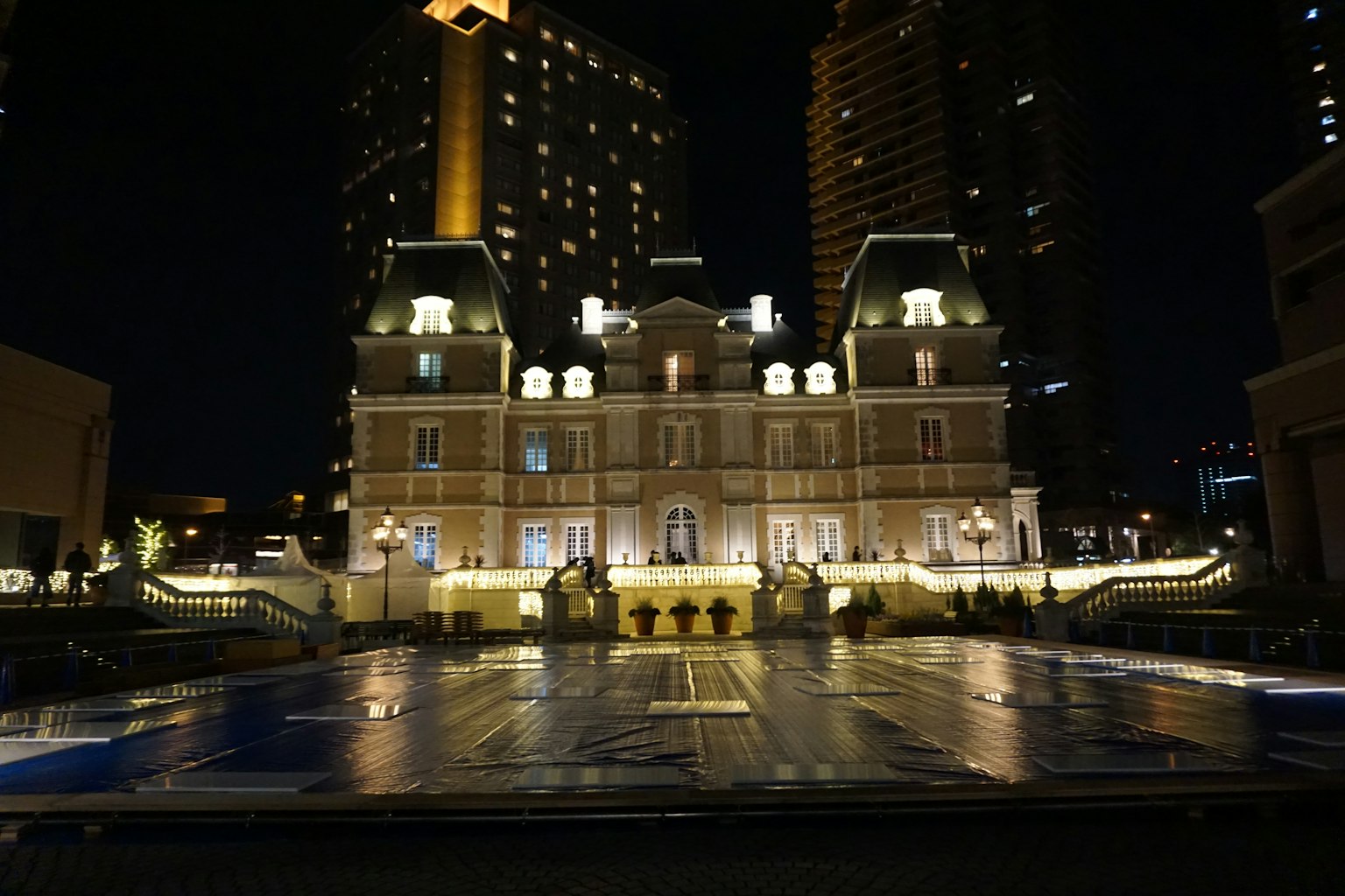 Edificio lussuoso illuminato di notte con riflessi sull'acqua