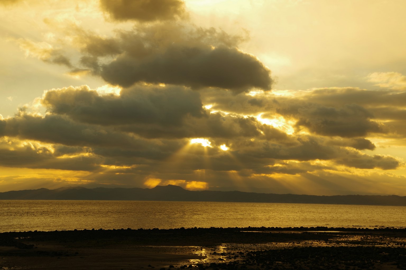 Sunset over the sea with dramatic clouds