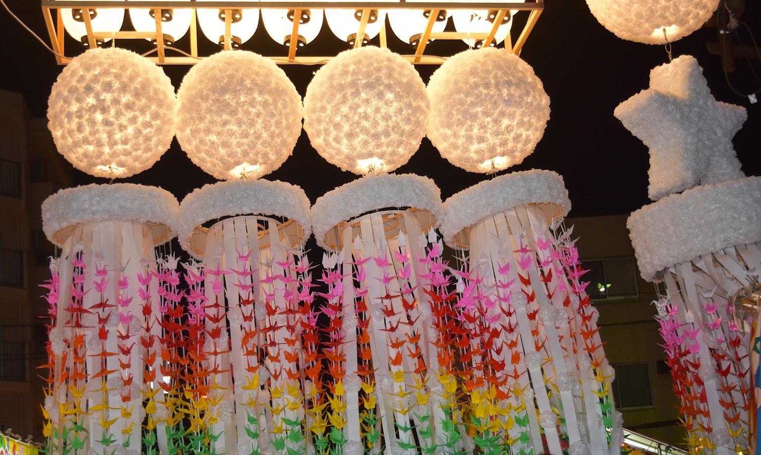 Colorful decorations with white lanterns hanging in a night scene