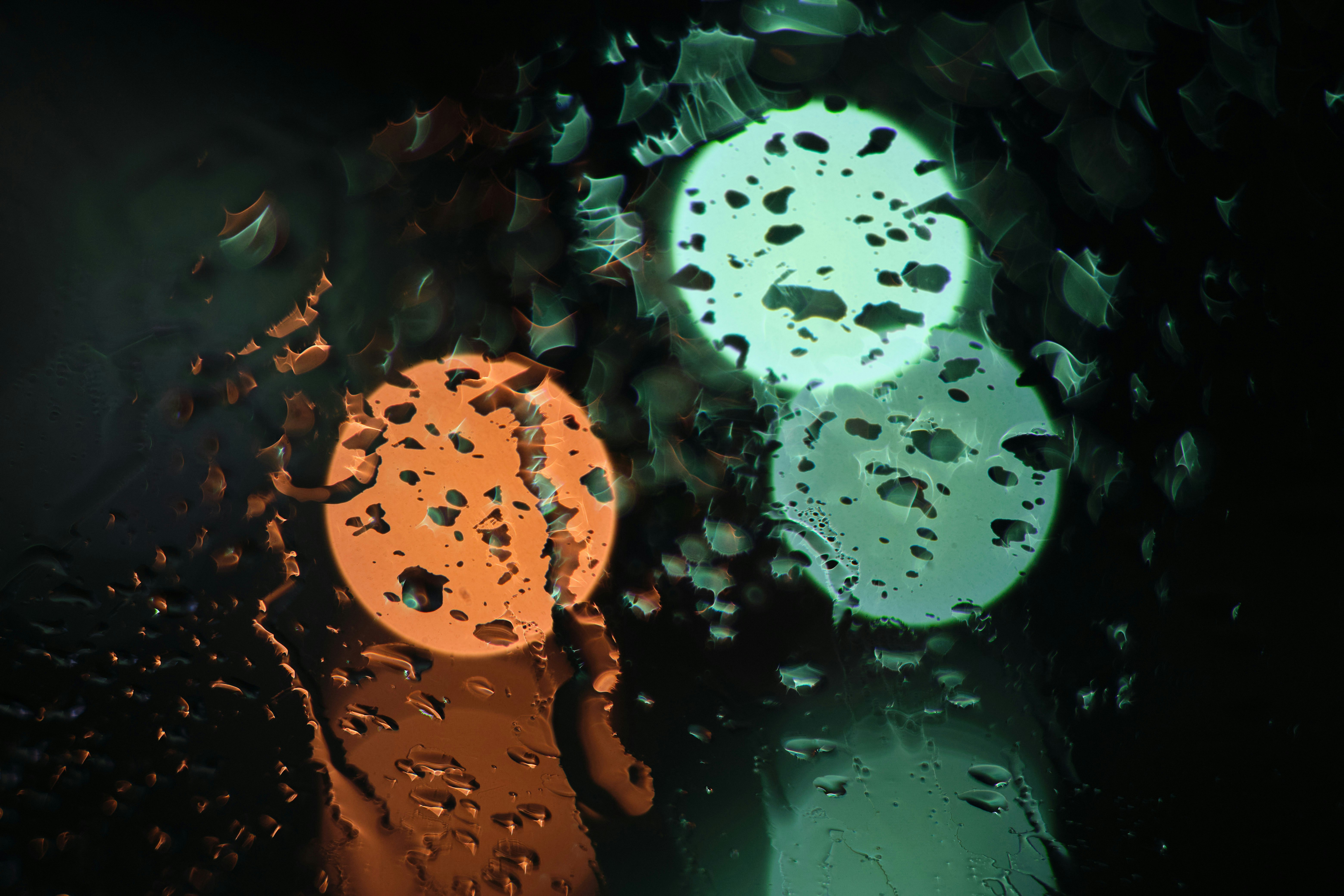 abstract glowing orange and green spheres in a dark background