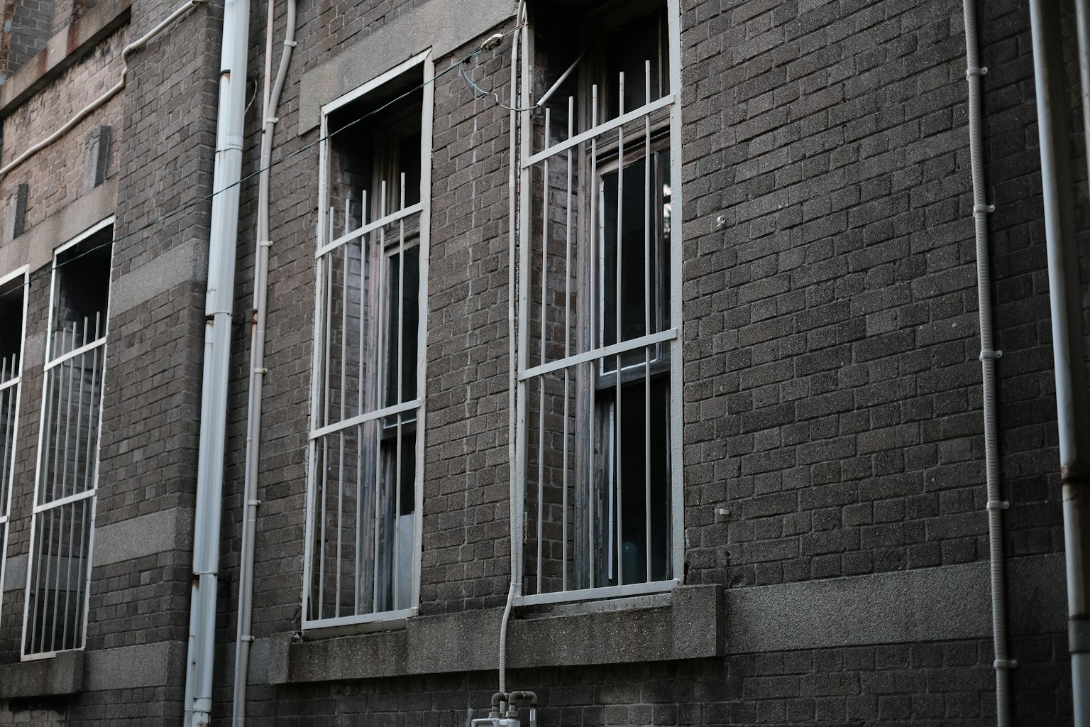 Iron-barred windows on an old building wall