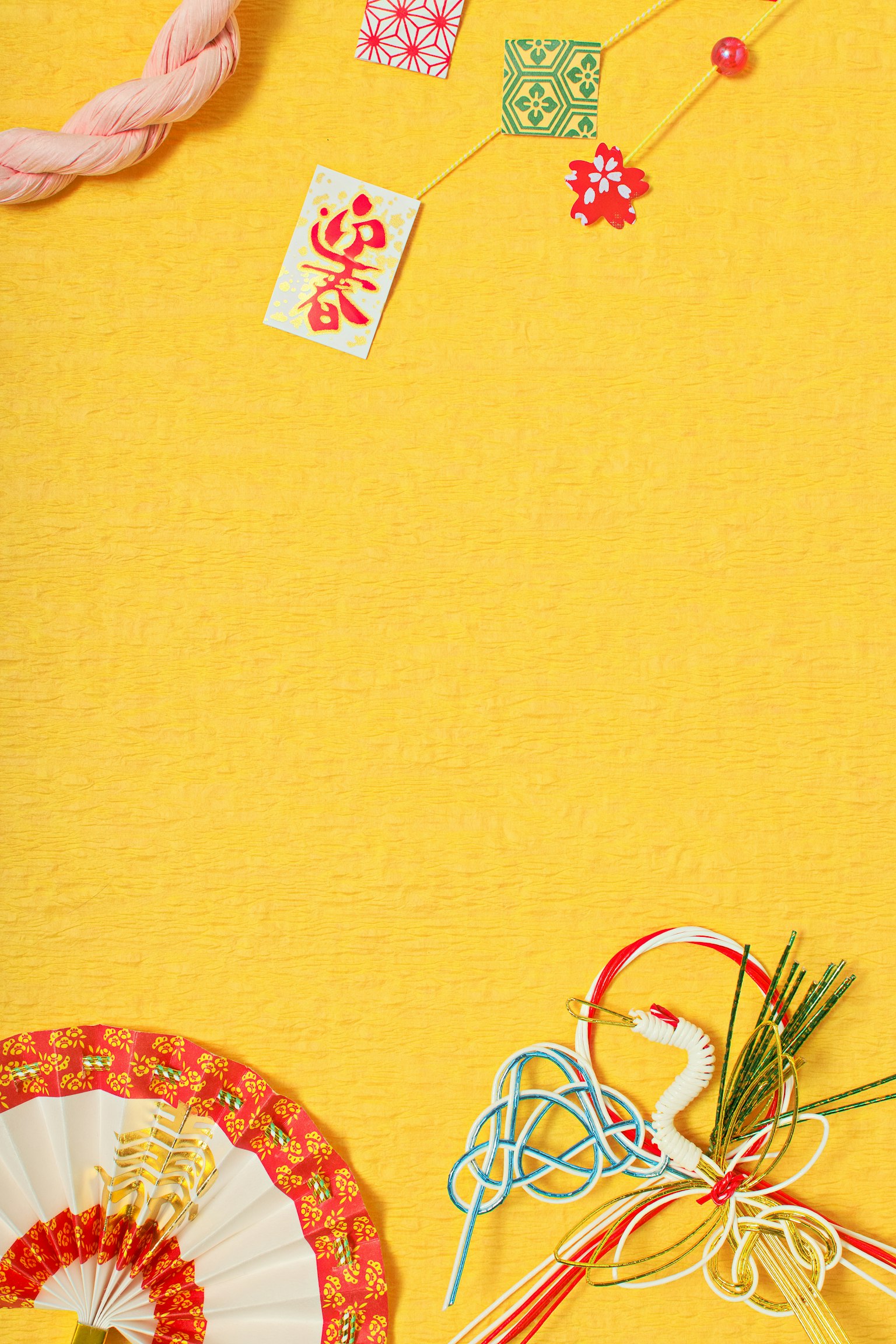 Colorful decorations and traditional ornaments arranged on a yellow background