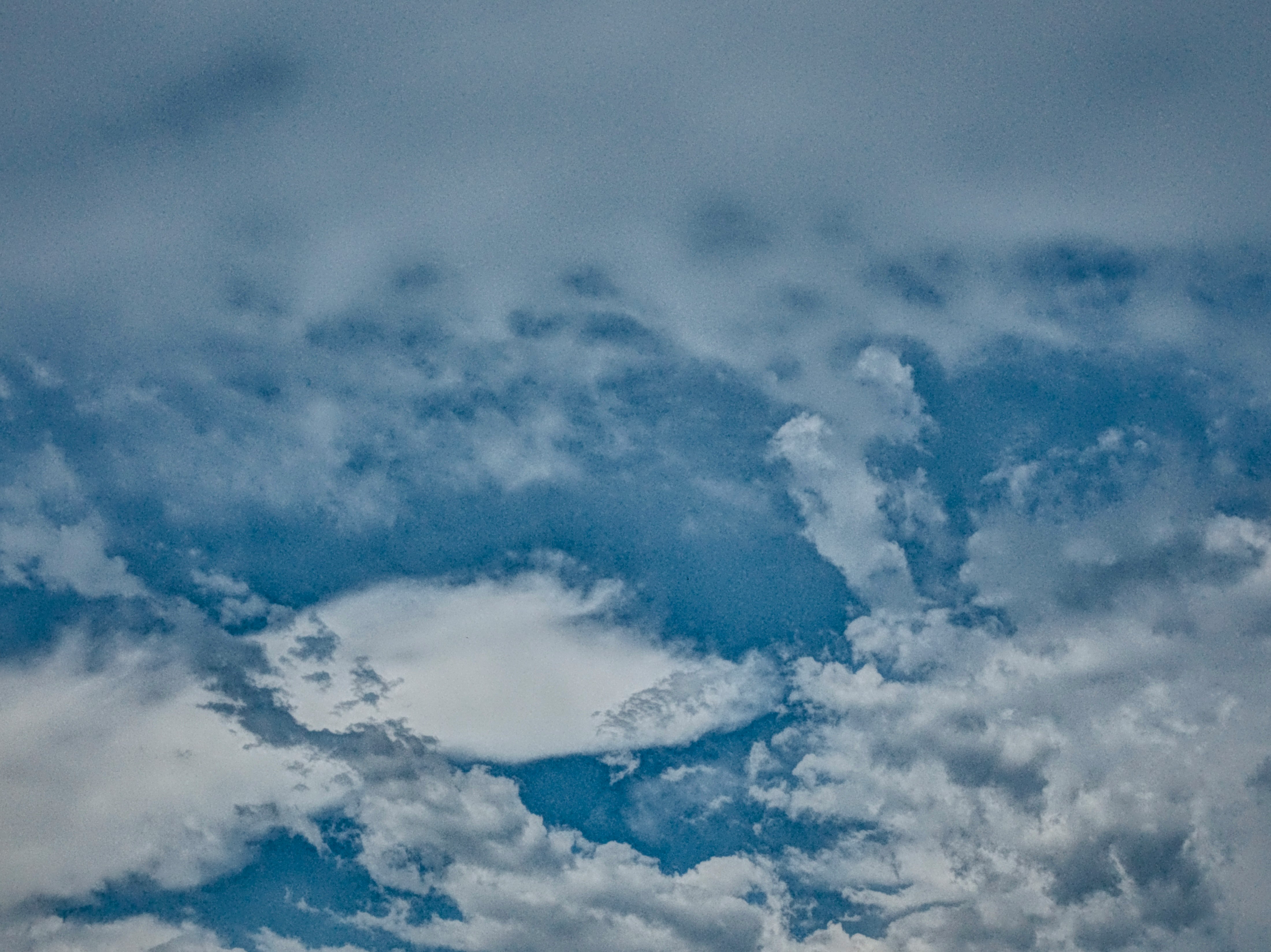 雲の間から立ち上る煙のような雲の渦画像