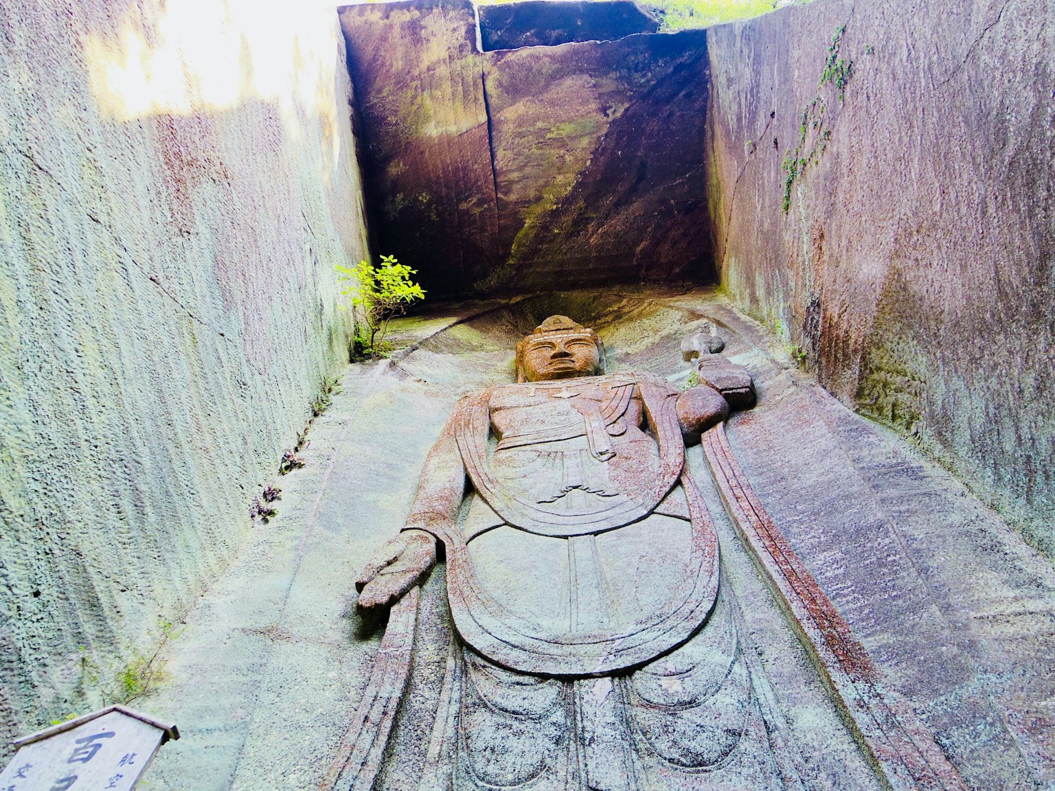 Ancient site interior featuring a stone-carved figure