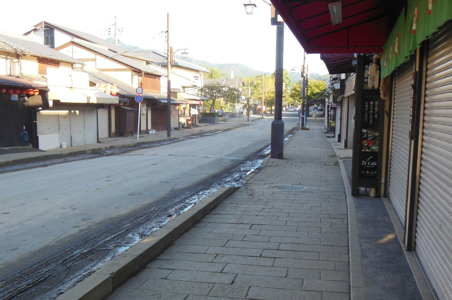 Quiet street lined with traditional buildings and sidewalk