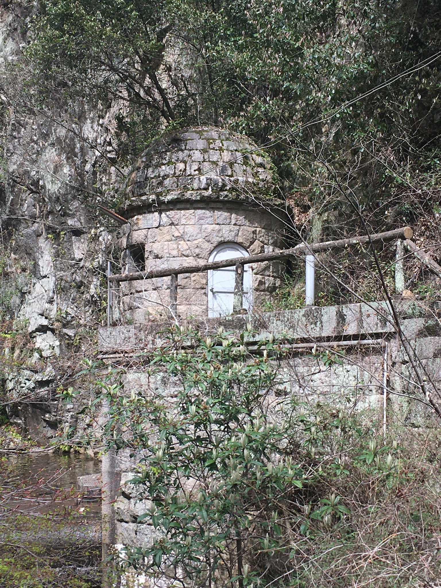 Cottage in pietra circondato da vegetazione