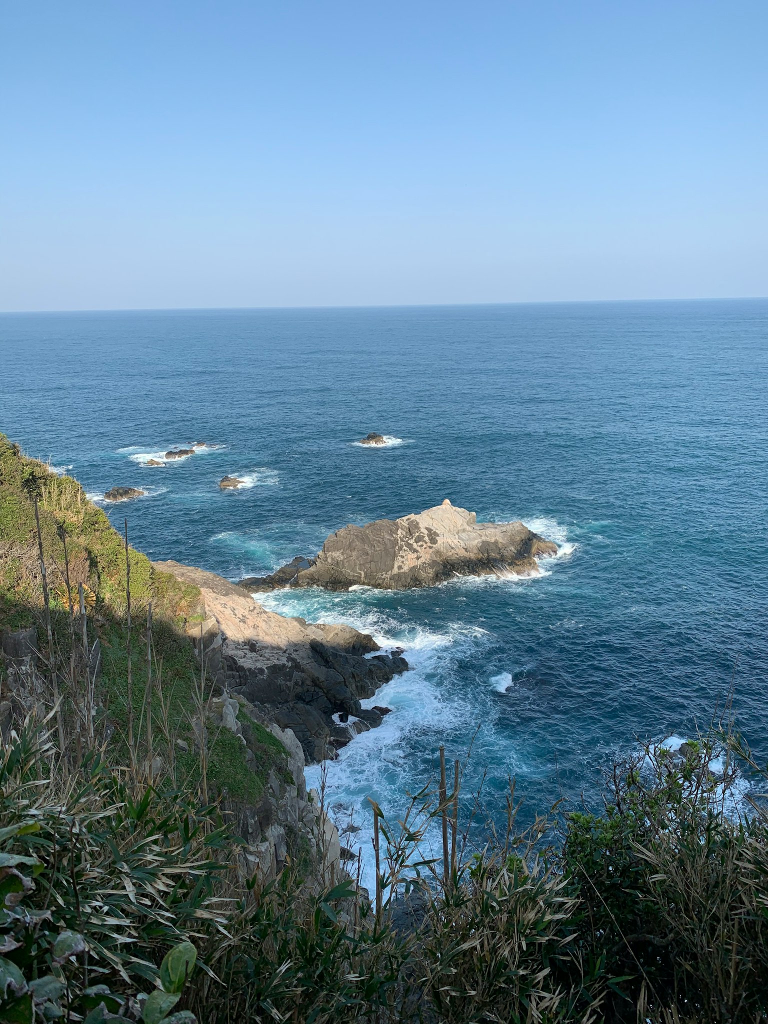 Coastal view featuring blue sea and rocky shore