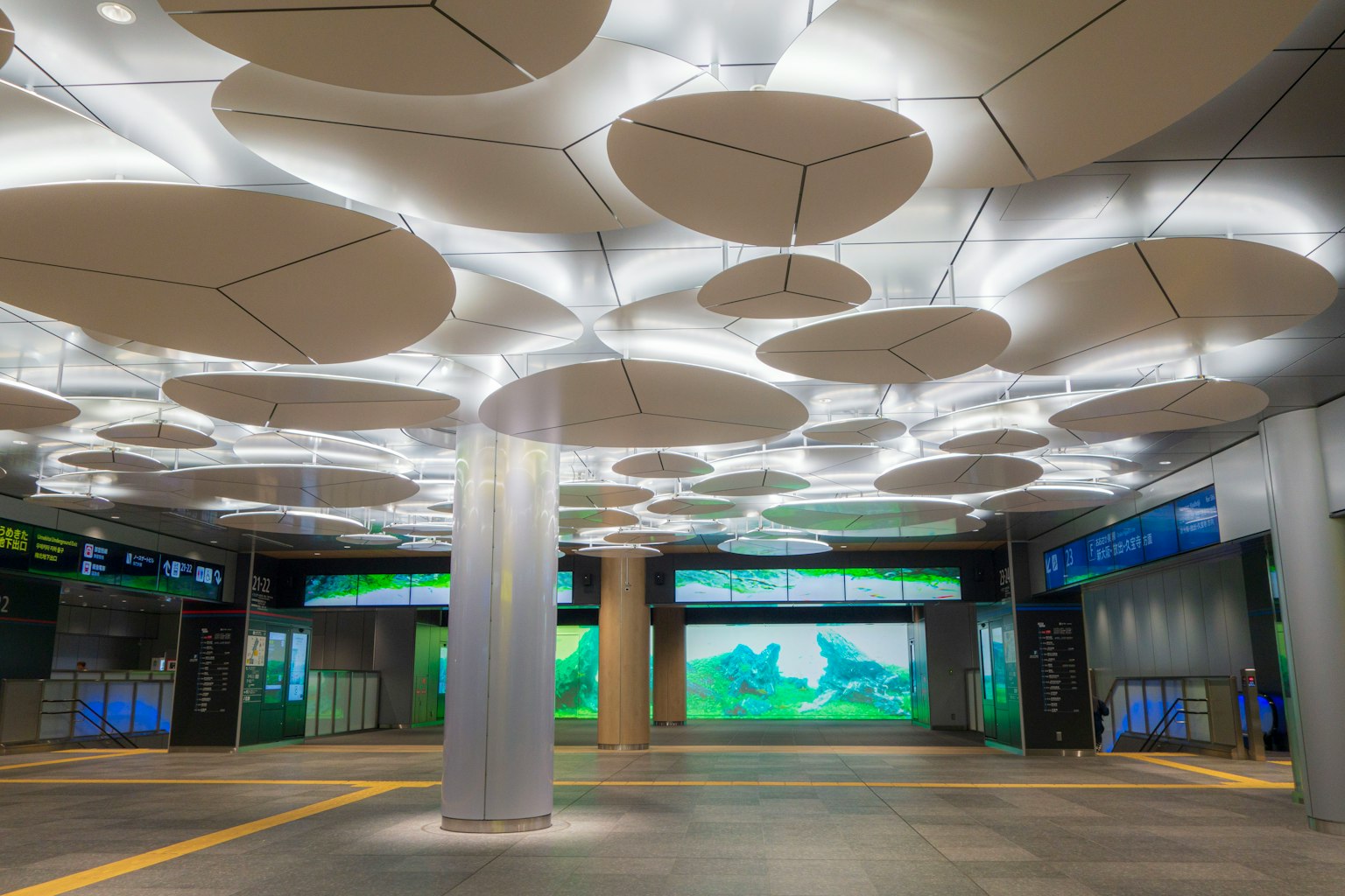 Modern station interior featuring bright lighting and circular ceiling design