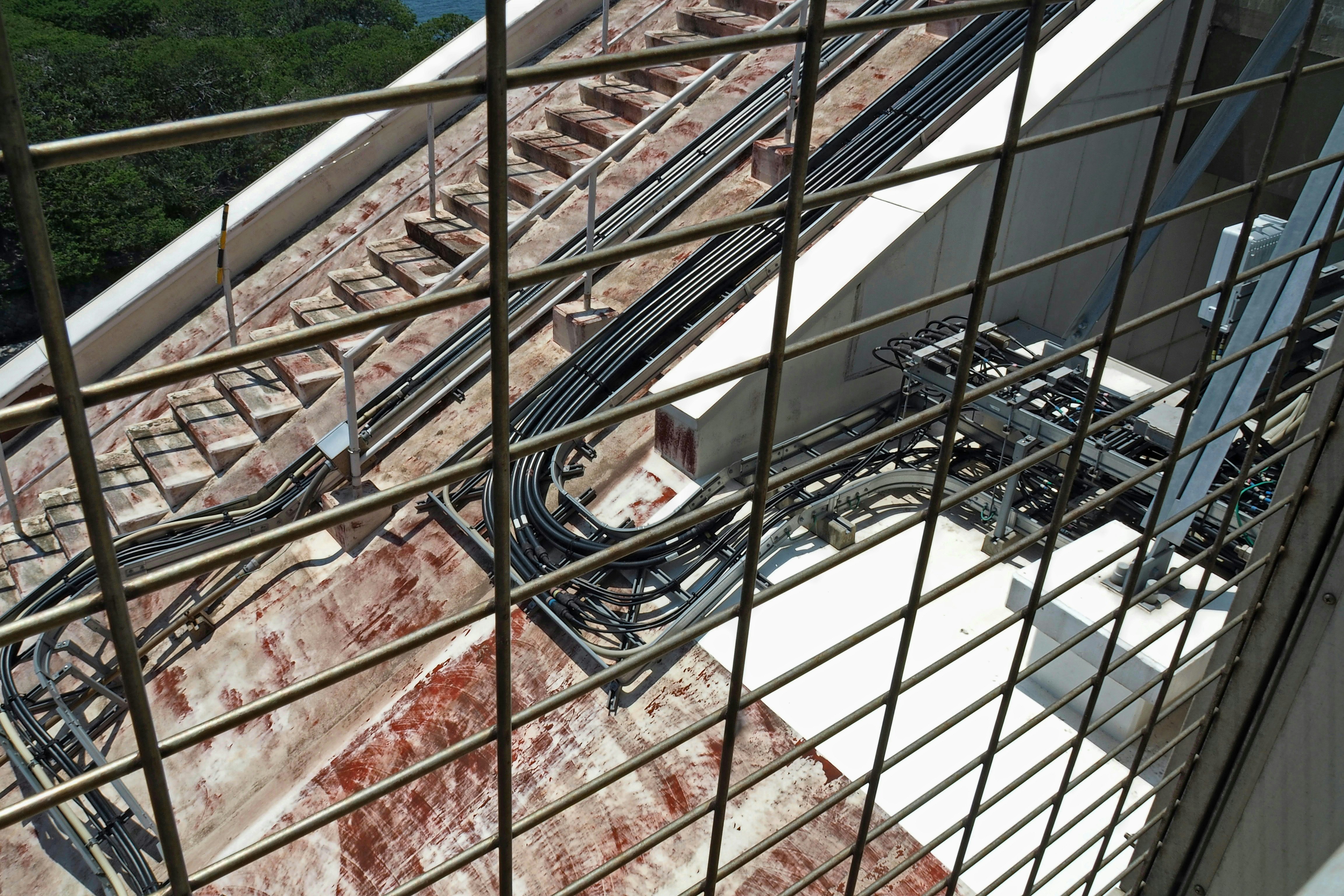 rooftop metal railing and exposed pipes on a building roof