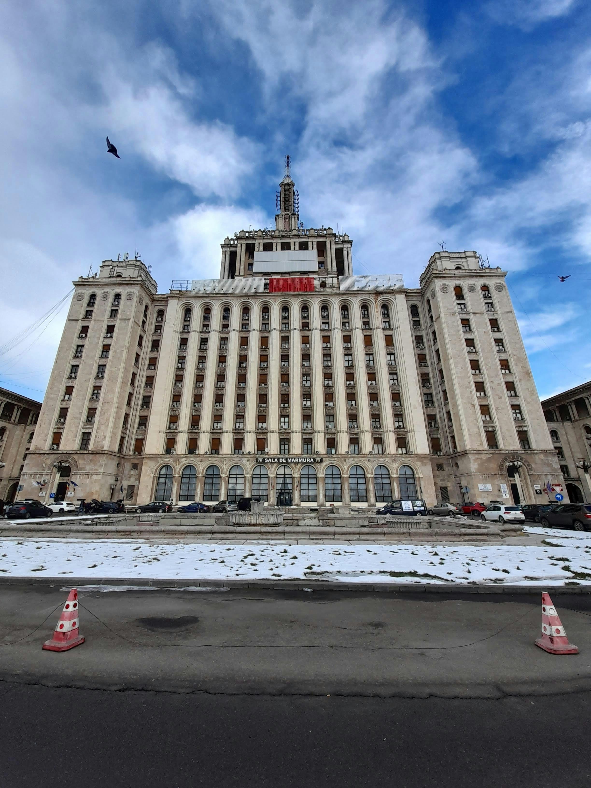 Large white monumental building viewed from a snowy street
