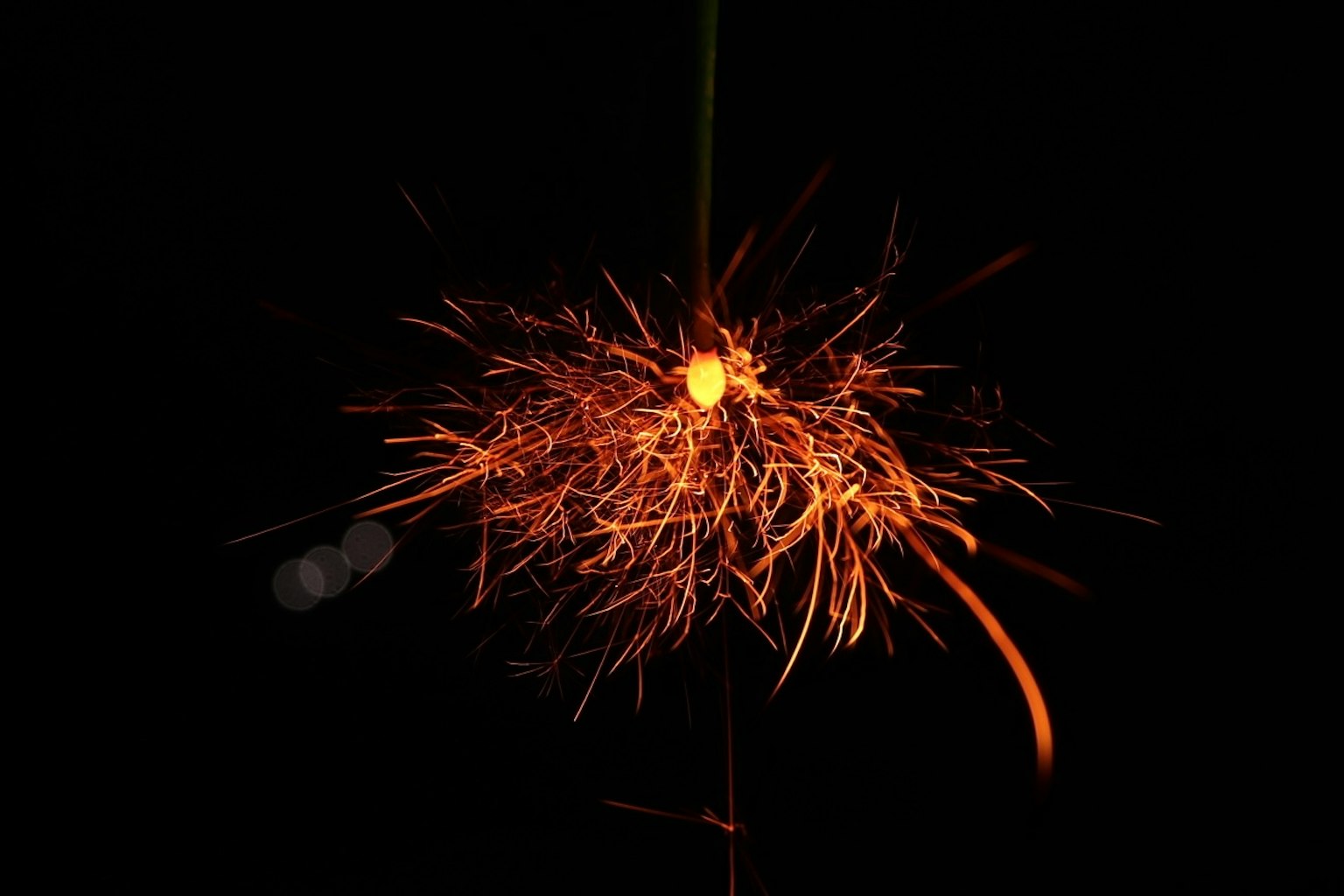 Cluster of sparks with a bright center against a black background