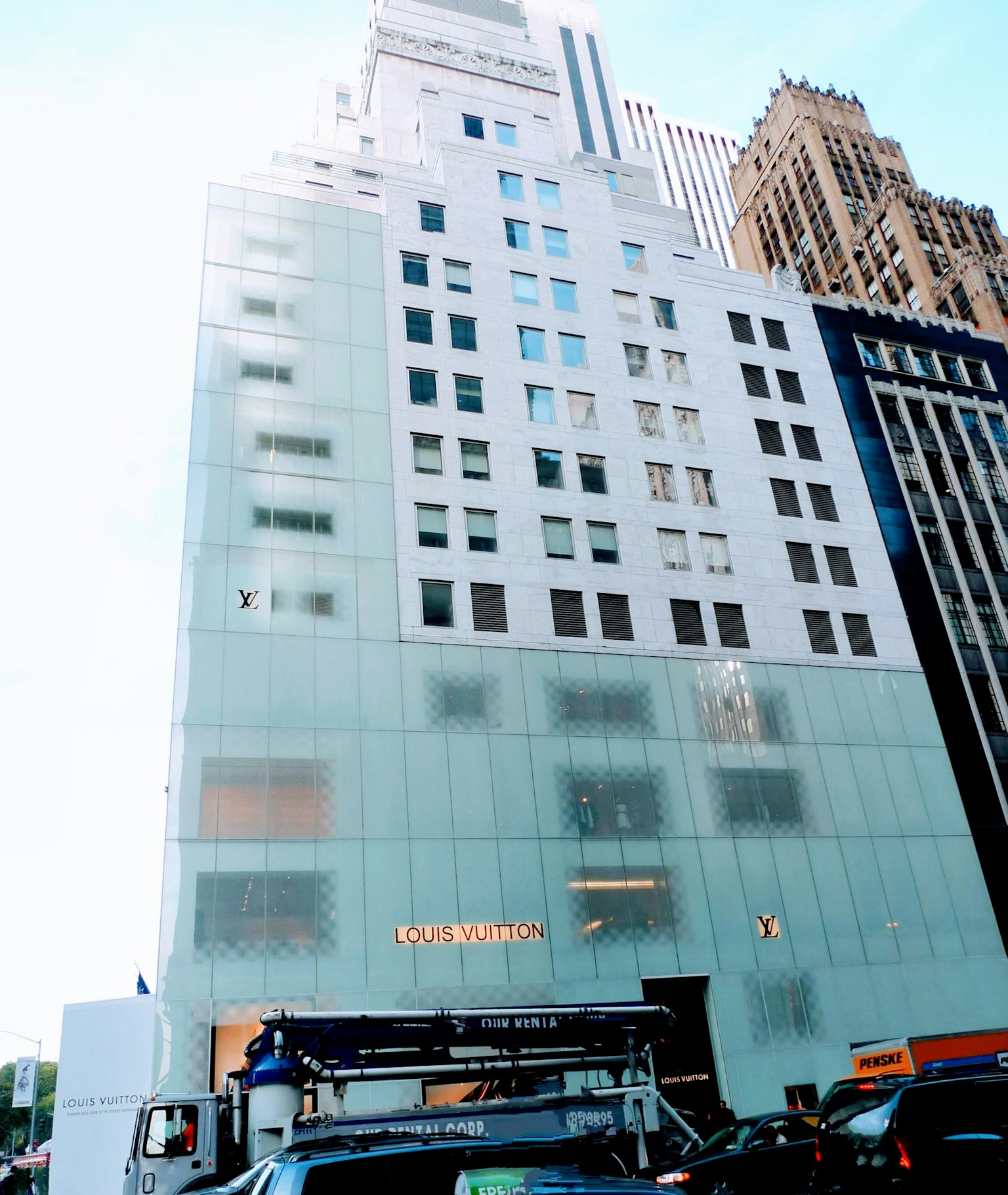 Urban landscape featuring a building with a distinctive glass facade