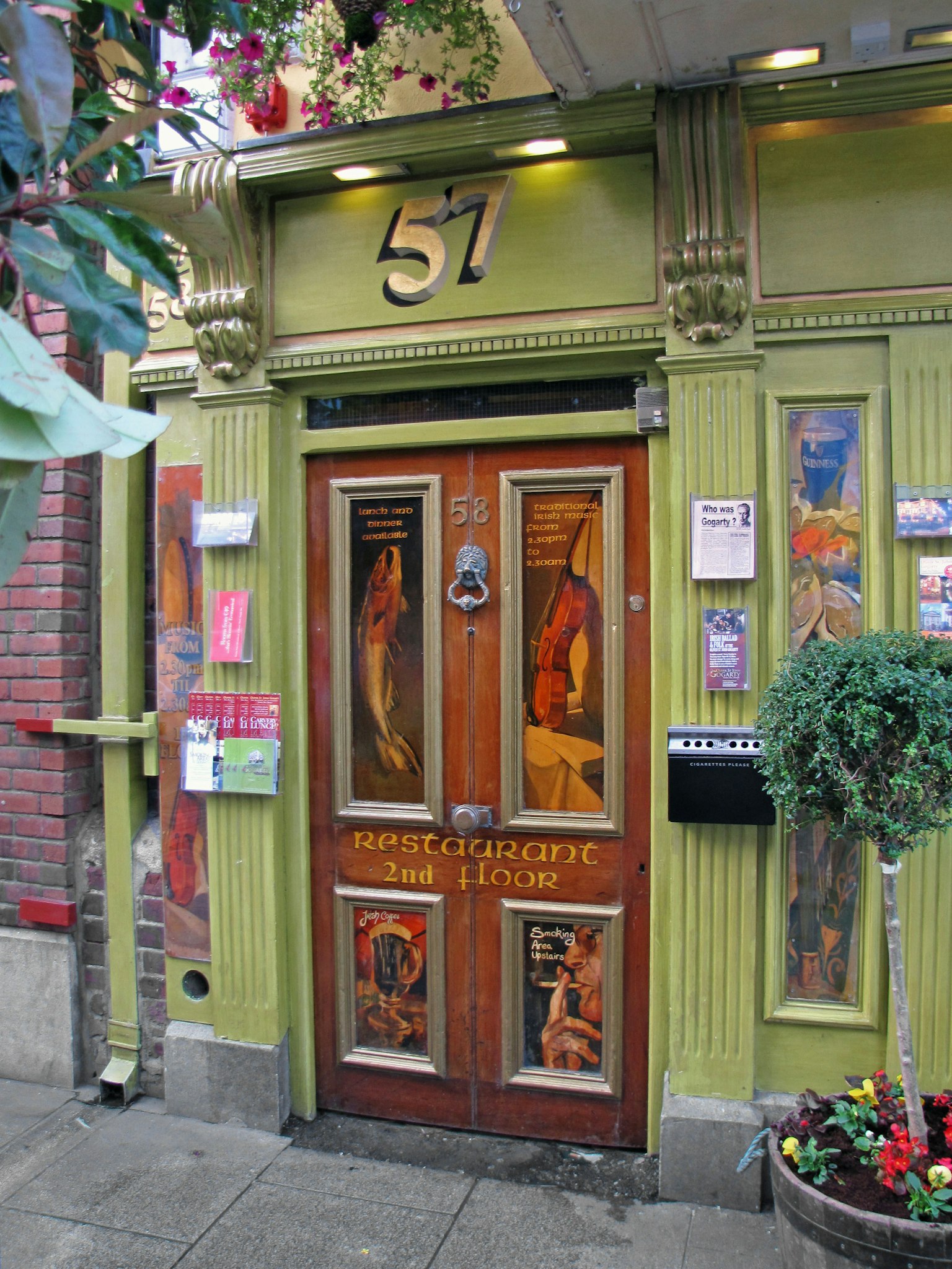 Porte numéro 57 avec des murs verts ornés d'art décoratif et de couleurs vives